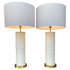 A pair of ivory lacquered real bamboo and brass lamps with bespoke linen shades