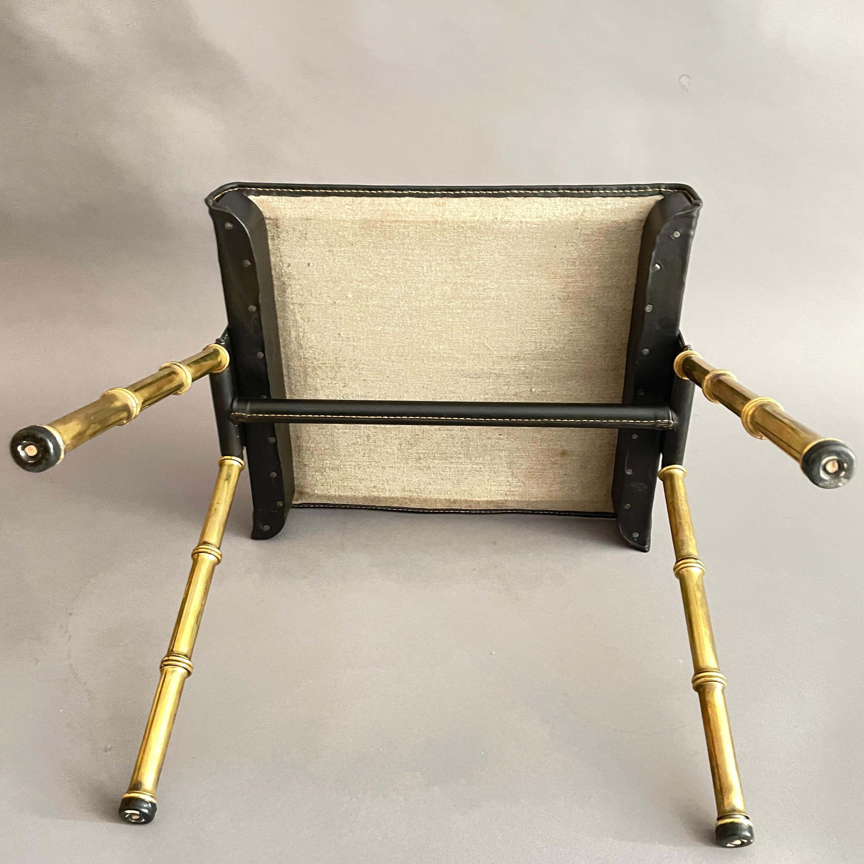 Mid-20th Century A pair of Jacques Adnet black leather and brass stools For Sale
