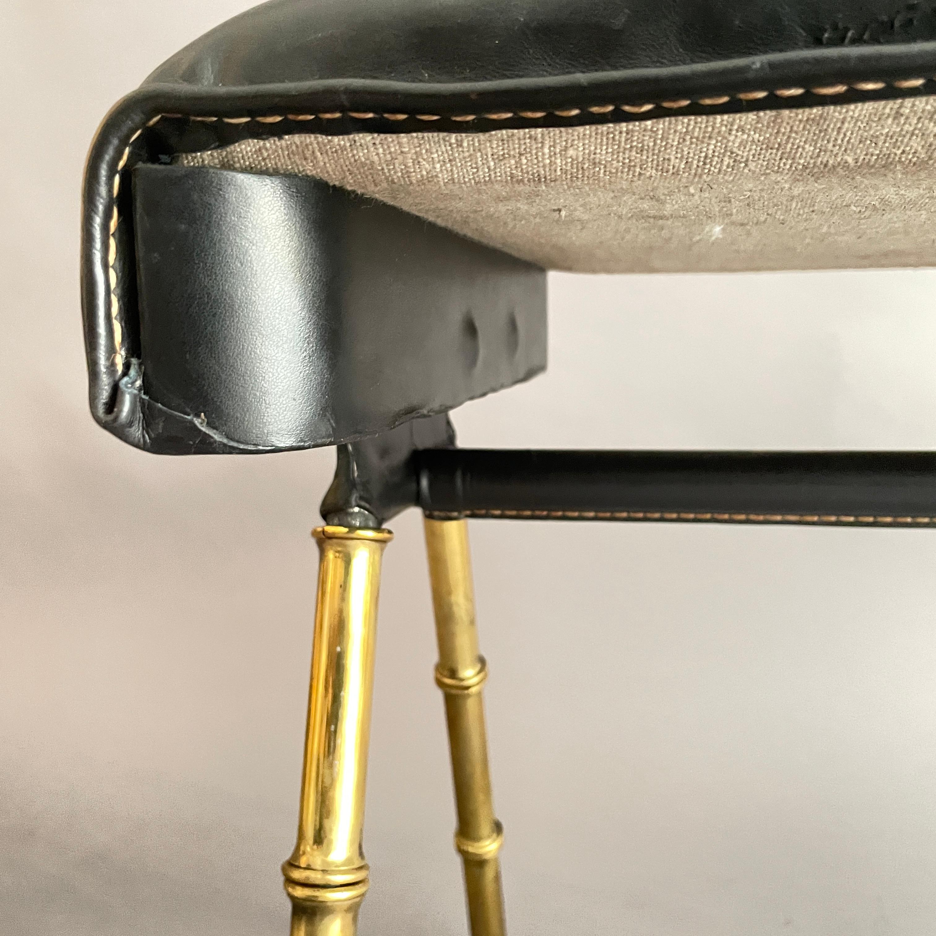 Brass A pair of Jacques Adnet black leather and brass stools For Sale