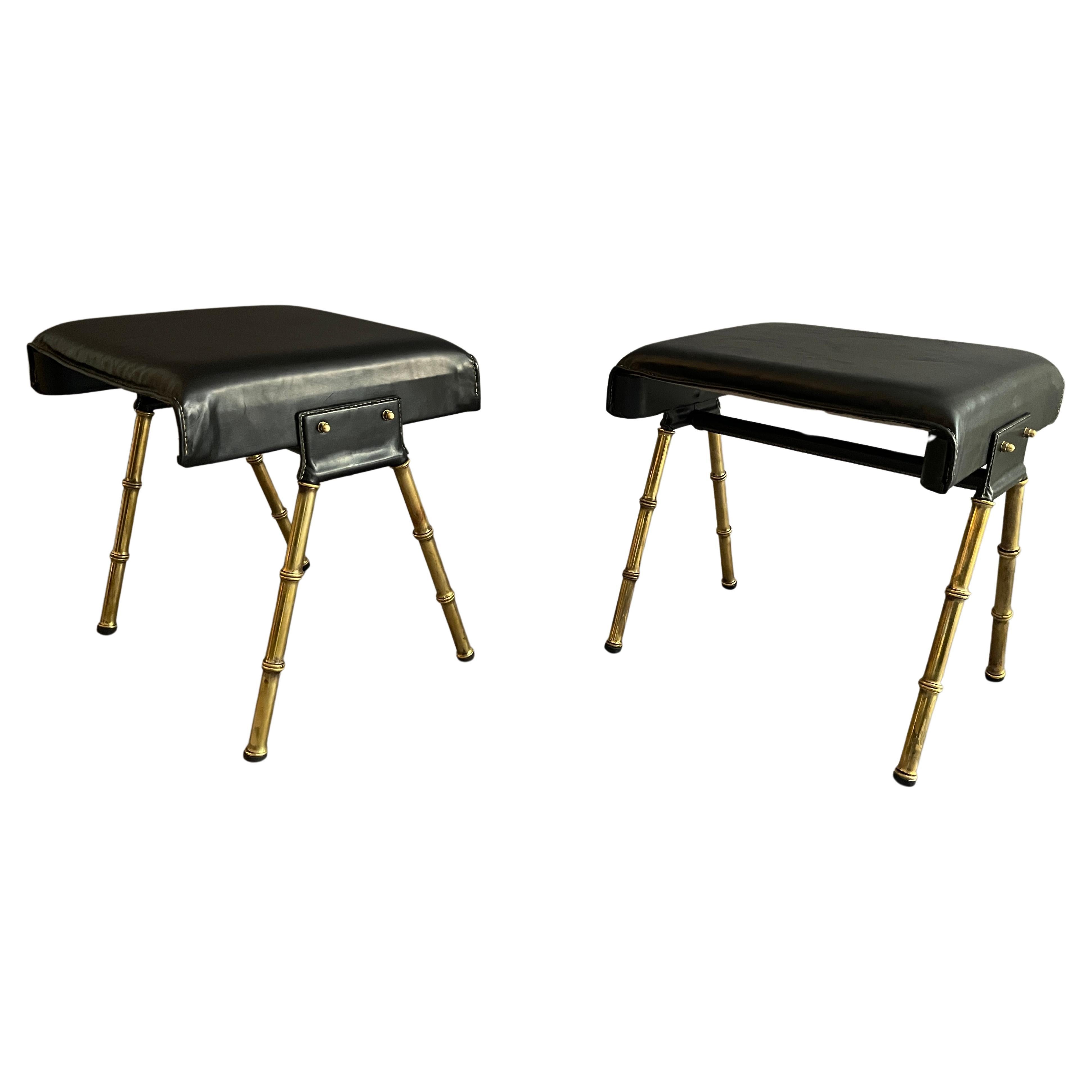 A pair of Jacques Adnet black leather and brass stools For Sale