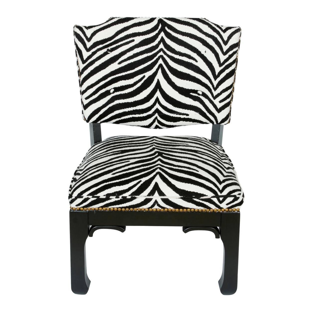 A pair of newly reupholstered black and white zebra print fabric low slipper chairs, ming styling, in the style of James Mont.