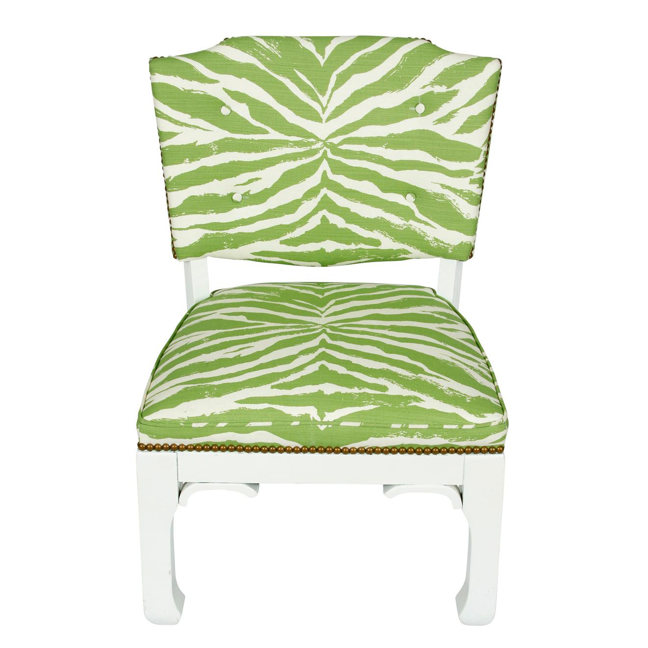 A pair of James Mont chairs newly upholstered in Quadrille green and white zebra fabric with nailhead trim and painted white wood frames.