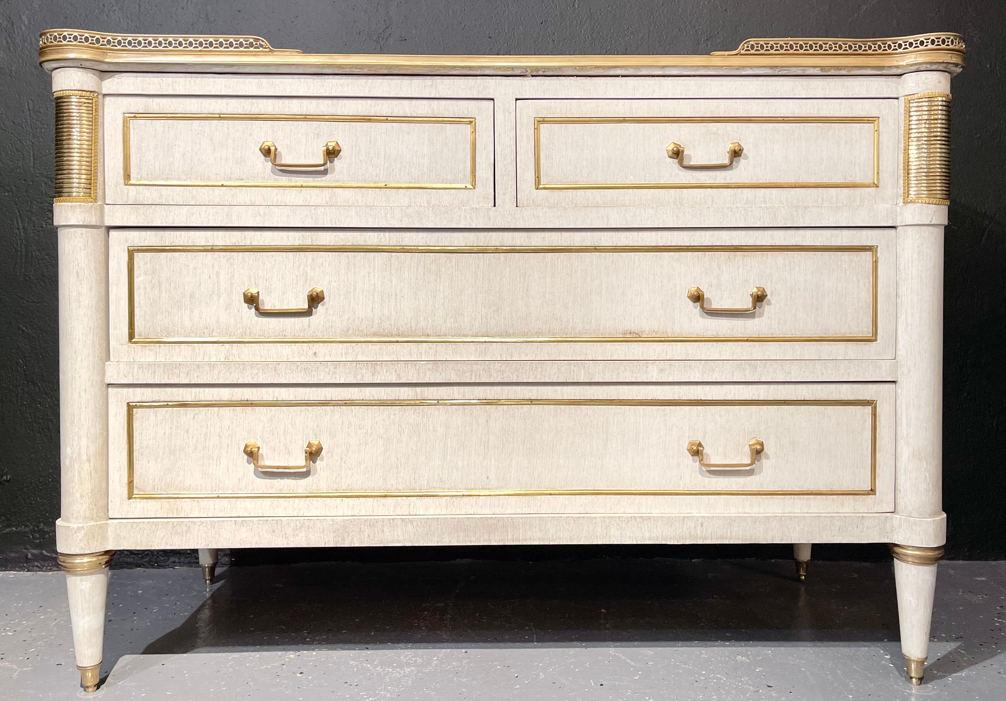 A pair of Jansen style marble top commodes or nightstands having a hand painted linen finish. A simply stunning and finely crafted pair of commodes or bedside stands in the Louis XVI style with a fine white and gray veined marble top set in a bronze