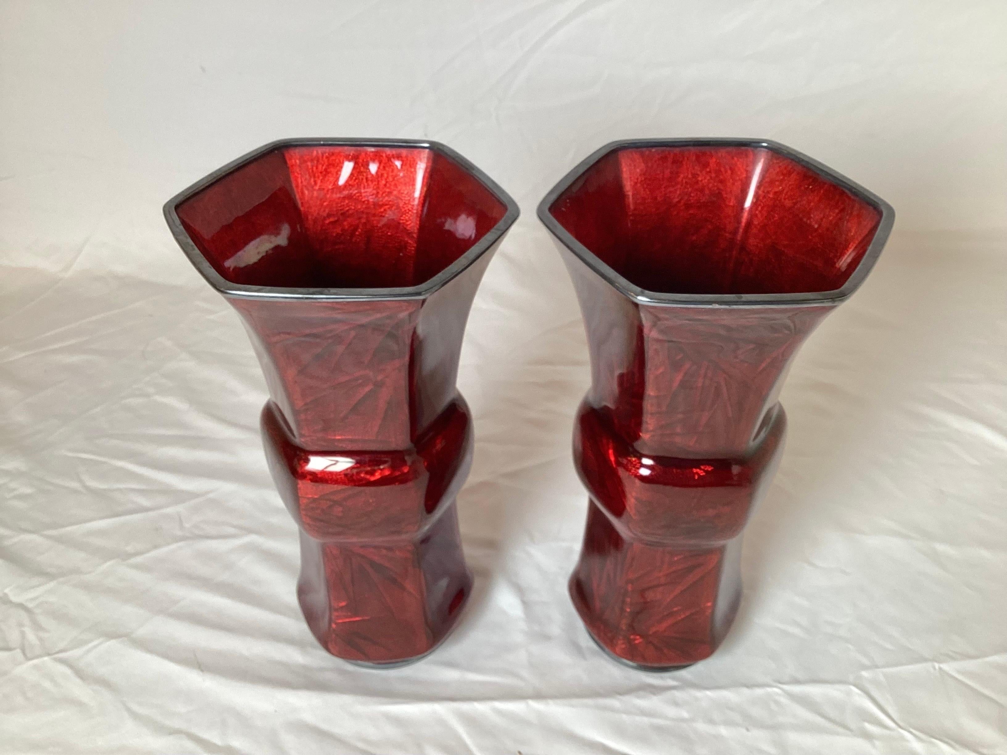 A pair of Japanese pigeon blood enamel cloisonné beaker vases with original storage wood box. The hexagonal shape with rich ruby color enamel over foil with silver rim at the top and base. Each with the ANDO GINBARI AKASUKA mark at the bottoms.