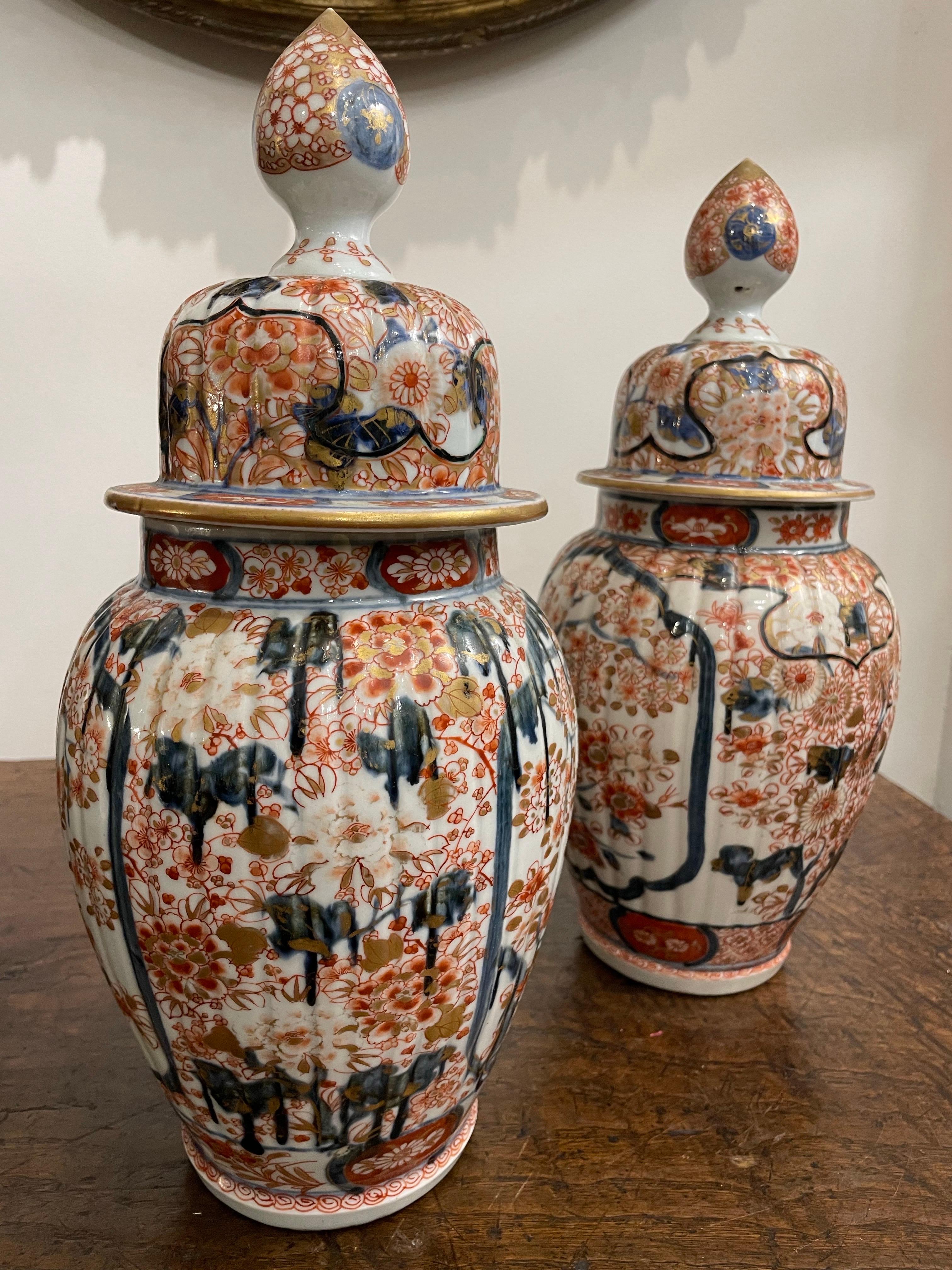 A Pair of Japanese Lidded Imari Vases, 19th Century
                                                                                              	 
Provenance:  Private Melbourne Collection. 

Description:
Each with a lobed inverted baluster body