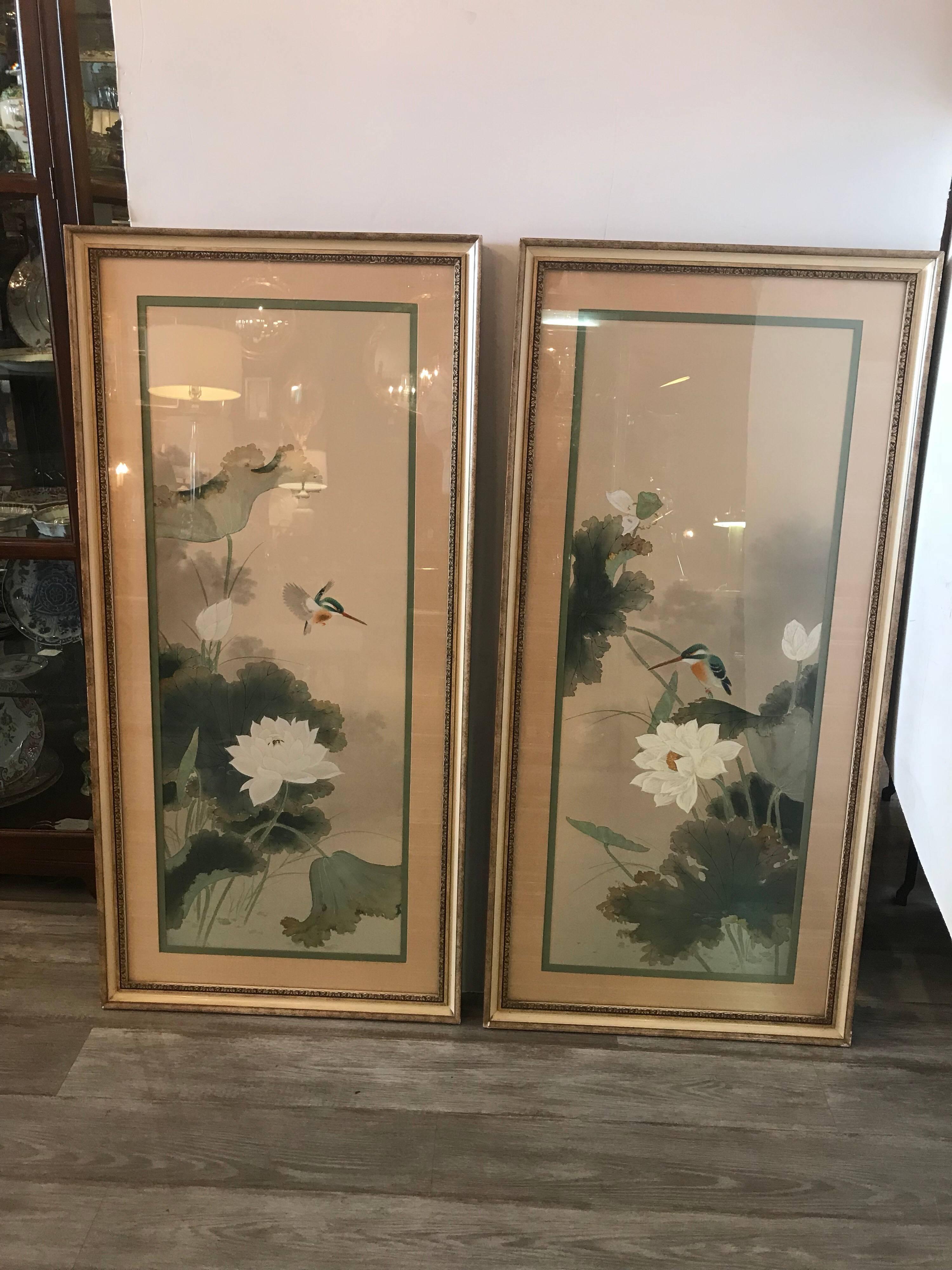 A large pair of hand Japanese paintings on silk. Framed and silk double matted in later frames. The floral branches with hummingbirds on each. Some wear to frames but the painting are in excellent condition. The paintings are signed by the artist in