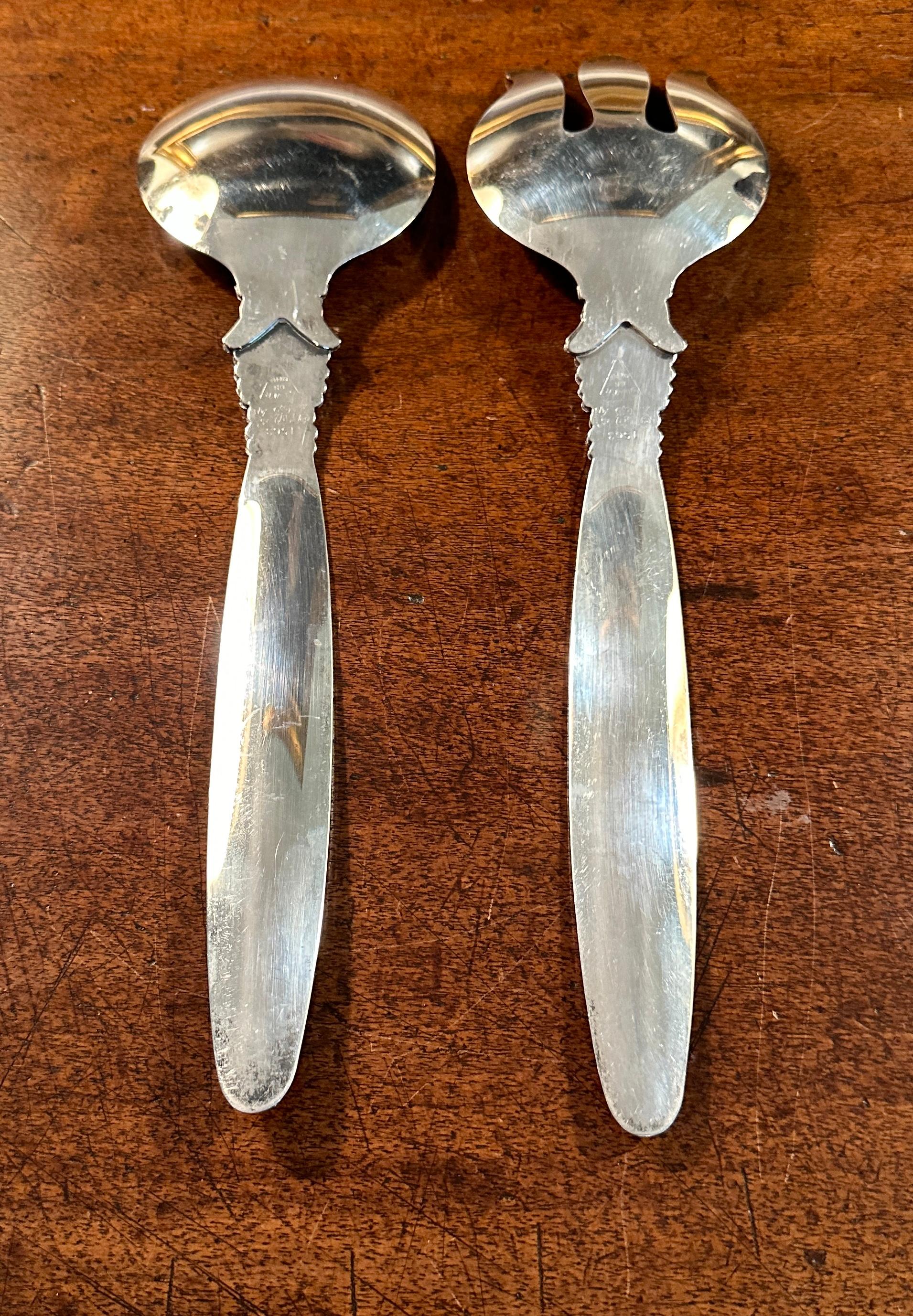 A very impressive pair of Salad or Side Dish Servers in the style of
George Jensen, the famous Danish Silver Smith.
The serving pieces are large and practical for a Buffet Service.
The detail on the handles are very  similar to the famous
George