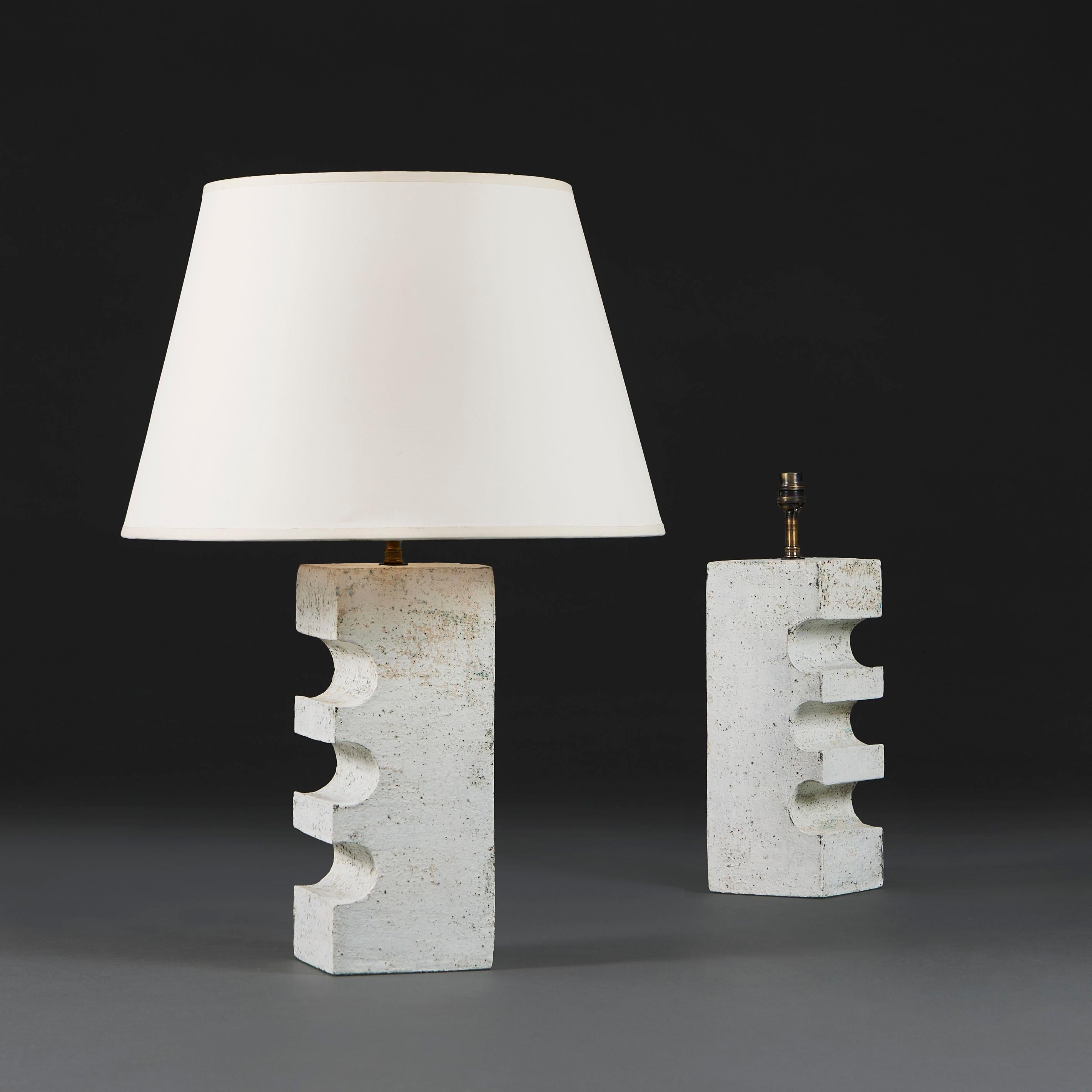 England, modern.

A pair of studio pottery stoneware lamps of cuboid form, with unusual jigsaw cutaway to one side, with patinated white glaze to the surface.

Lead time: 5-7 weeks. Please enquire for stock availability.

Photographed with an 18”