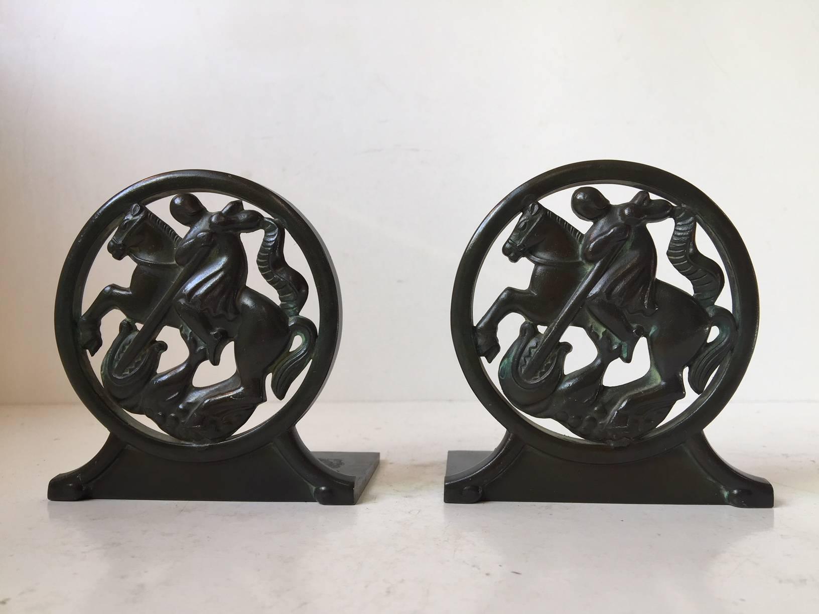 A pair of 1930s bookends by Just Andersen. Composed of green patinated disko metal (his own alloy invention). Both stamped by maker. Serial number: 1626.