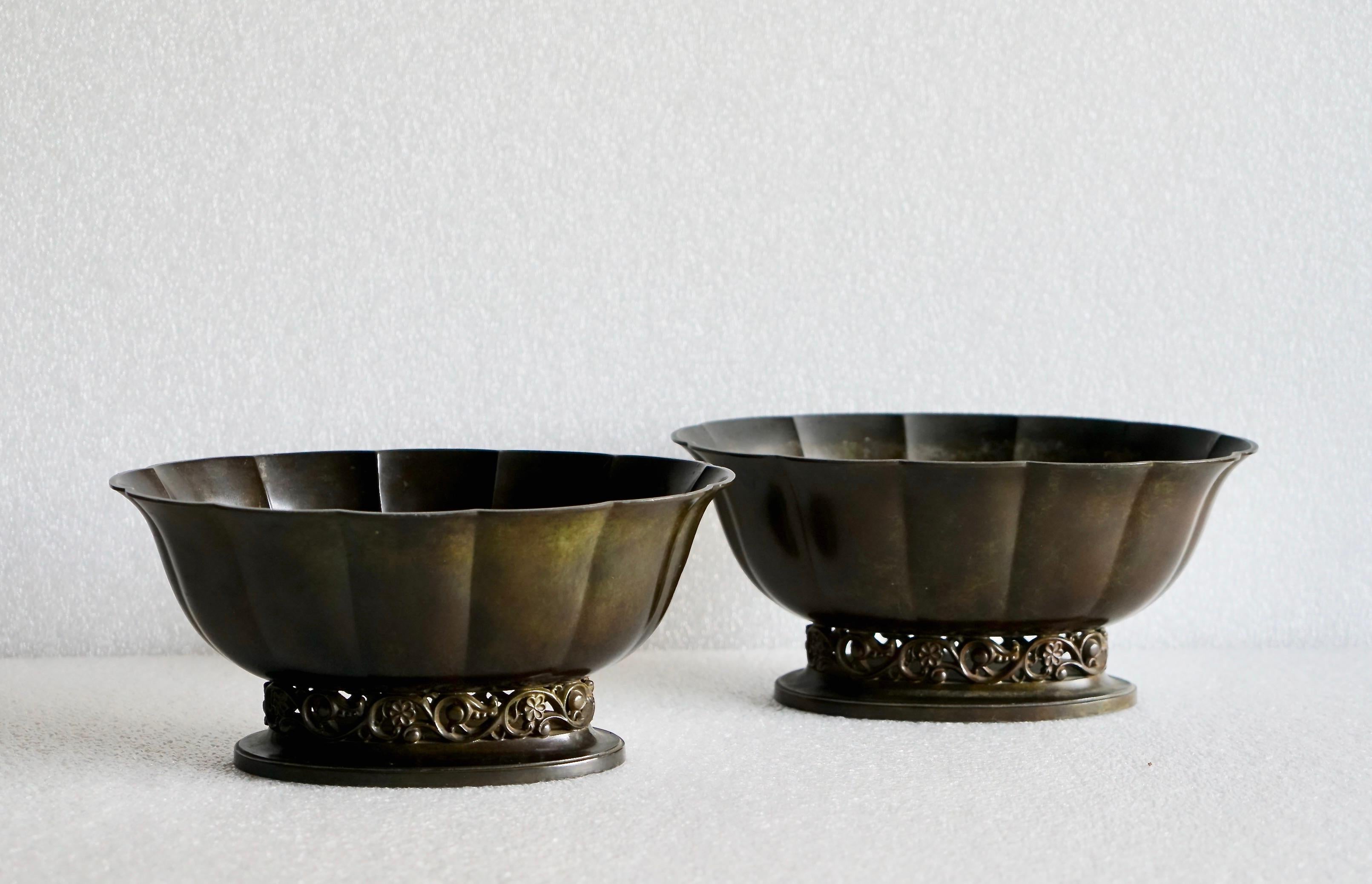 A pair of Just Andersen (1884-1943) patinated disco metal planter, model 164, Denmark, 1926-29. Minor scratches, very good vintage condition. Stamped with JA model number.