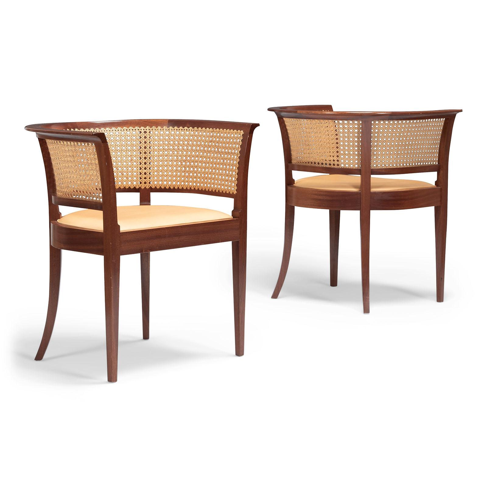 A pristine pair of Faaborg chairs in mahogany, back with cane and seats upholstered with natural leather.
The Faaborg chair was originally designed in 1914 by Kaare Klint for The Museum of Faaborg, Denmark
Made by cabinetmaker's Rud. Rasmussen,
