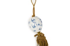 A pair of kakemono weight in porcelain decorated with dragons in a cloudy sky