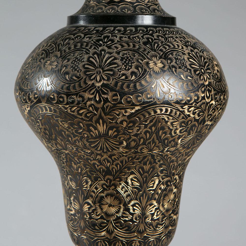 A matched pair of Kashmiri baluster lamps with etched gilt foliate decoration on a dark ground.