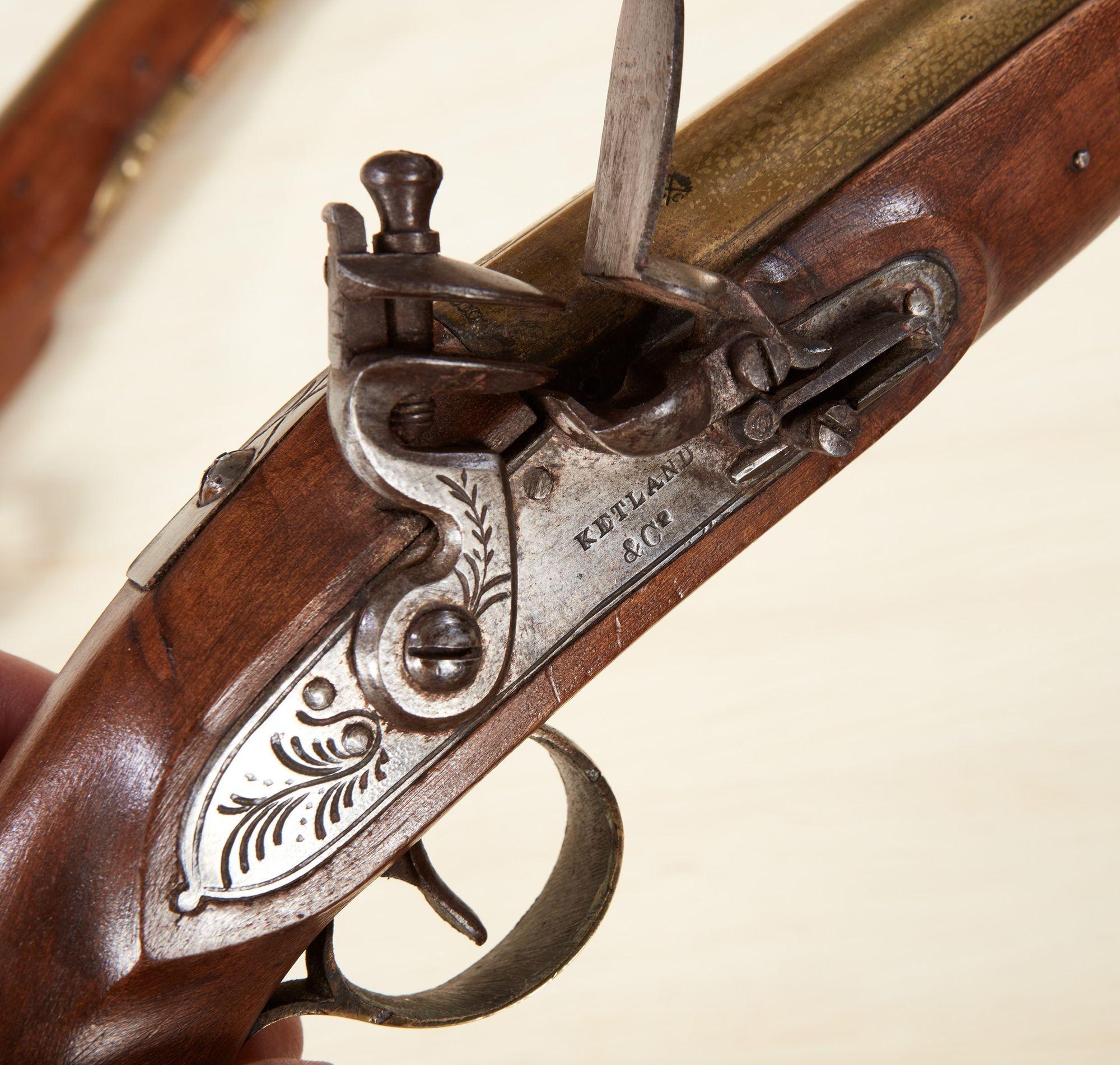 A pair of 18th century English flintlock pistols by Ketland and Co. having proof-marked brass barrels, walnut stocks and engraved steel locks, both with original ramrods and both in mechanically sound condition.
Thomas Ketland & Co. was a very