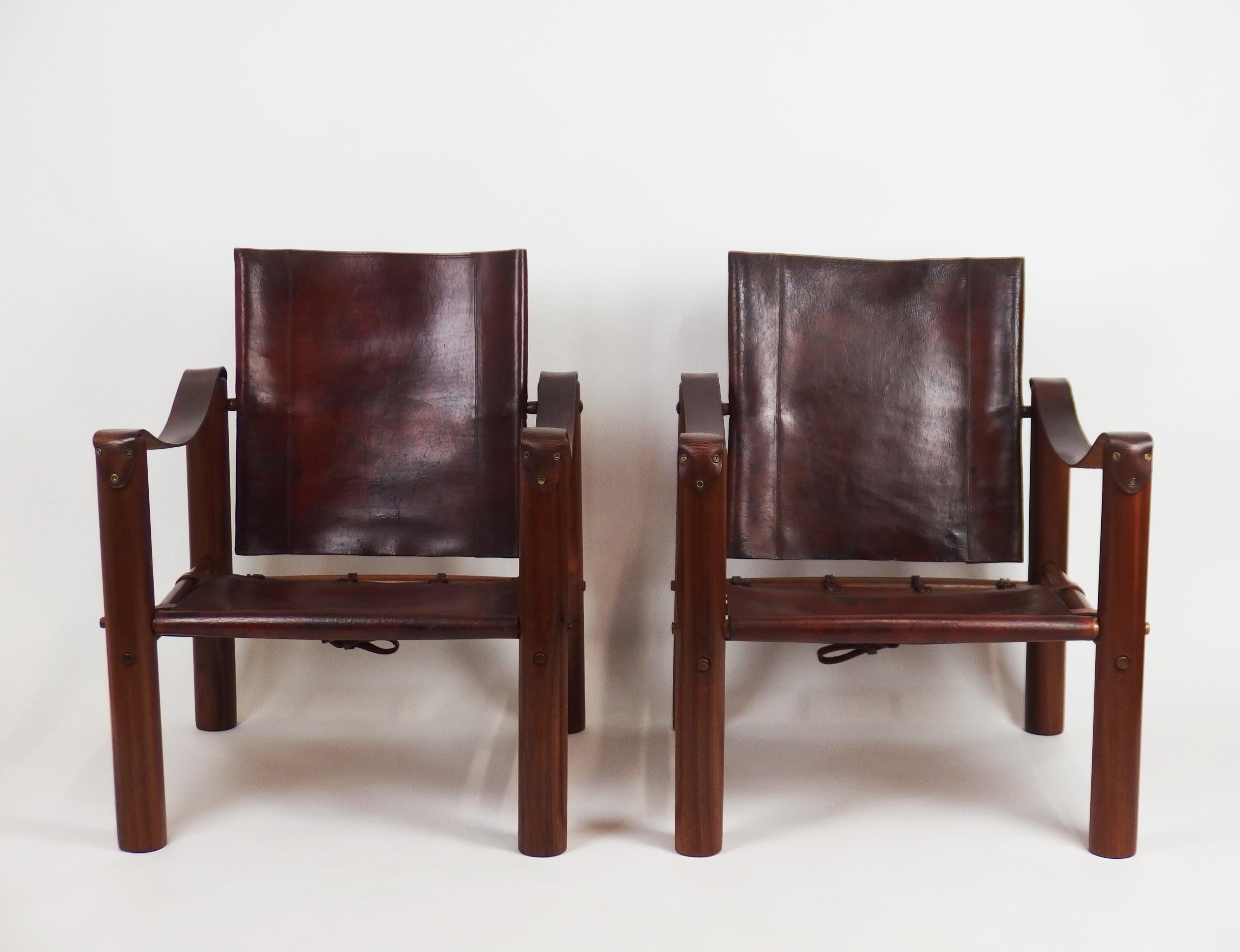 A pair of armchairs with clear mahogany legs and brown stitched leather on backs and seats.
Eileen Gray customized a same model with checkered black and white square patterns
on back and seat for the car designer Jean-Henri Labourdette circa