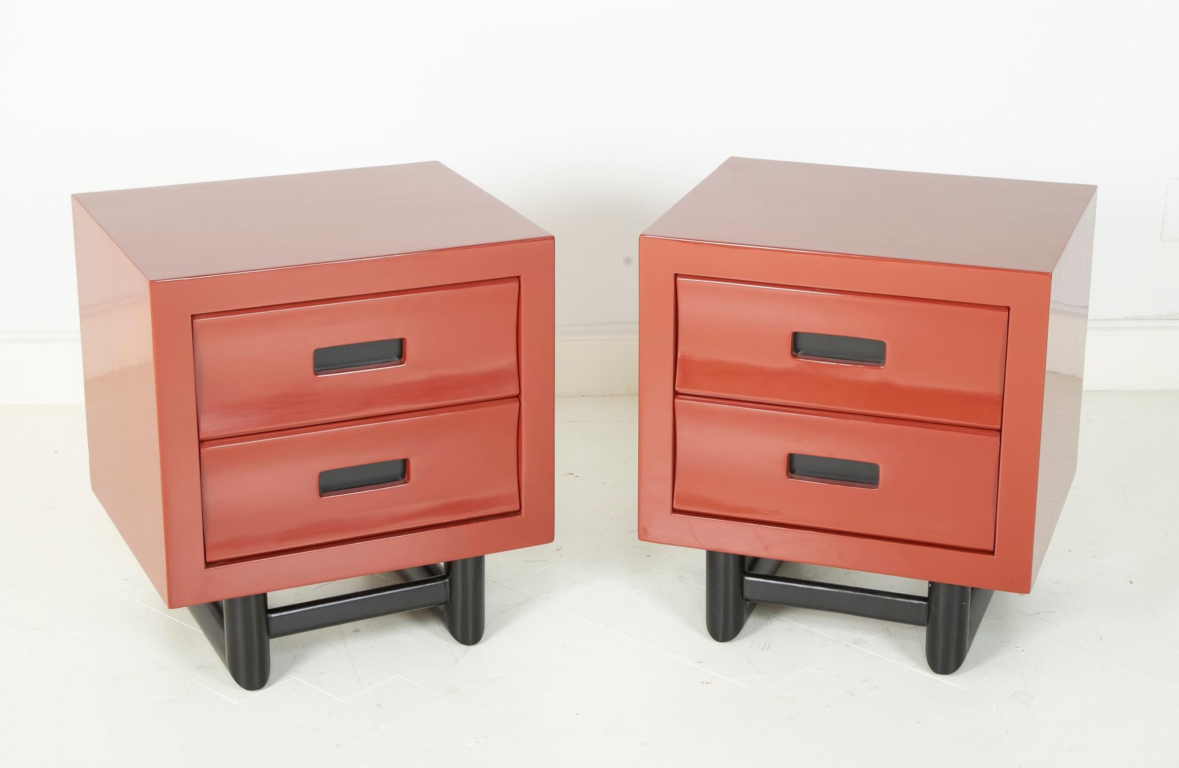 A pair of red lacquer bedside tables in the manner of Jay Spectre.