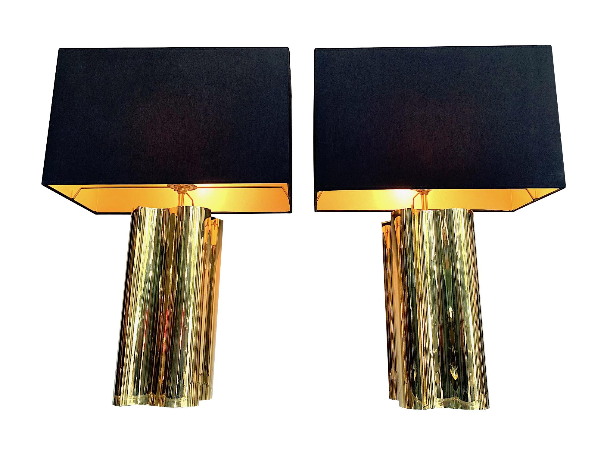 A pair of large 1970s brass lamps with interesting curved corners and new bespoke black shades with gold linings. Re wired with new brass fittings and antique gold cord flex and PAT tested.