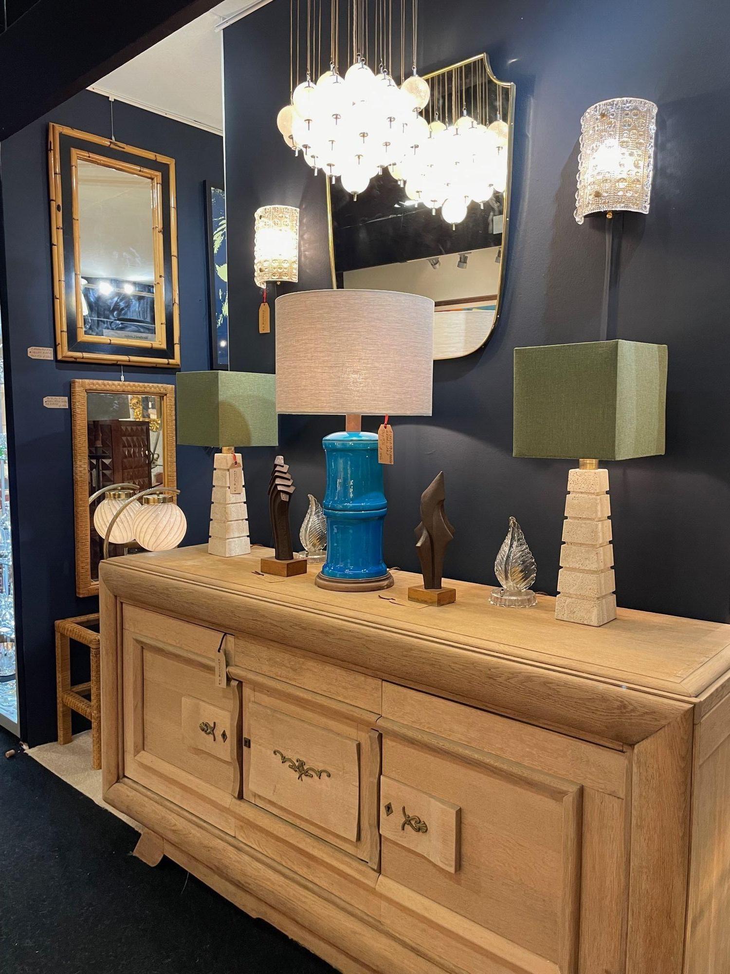 A pair of large 1970s Italian travertine lamps with grooved detail and brass fittings. Re wired with new brass fittings, antique gold cord flex and PAT tested with new bespoke linen shades.