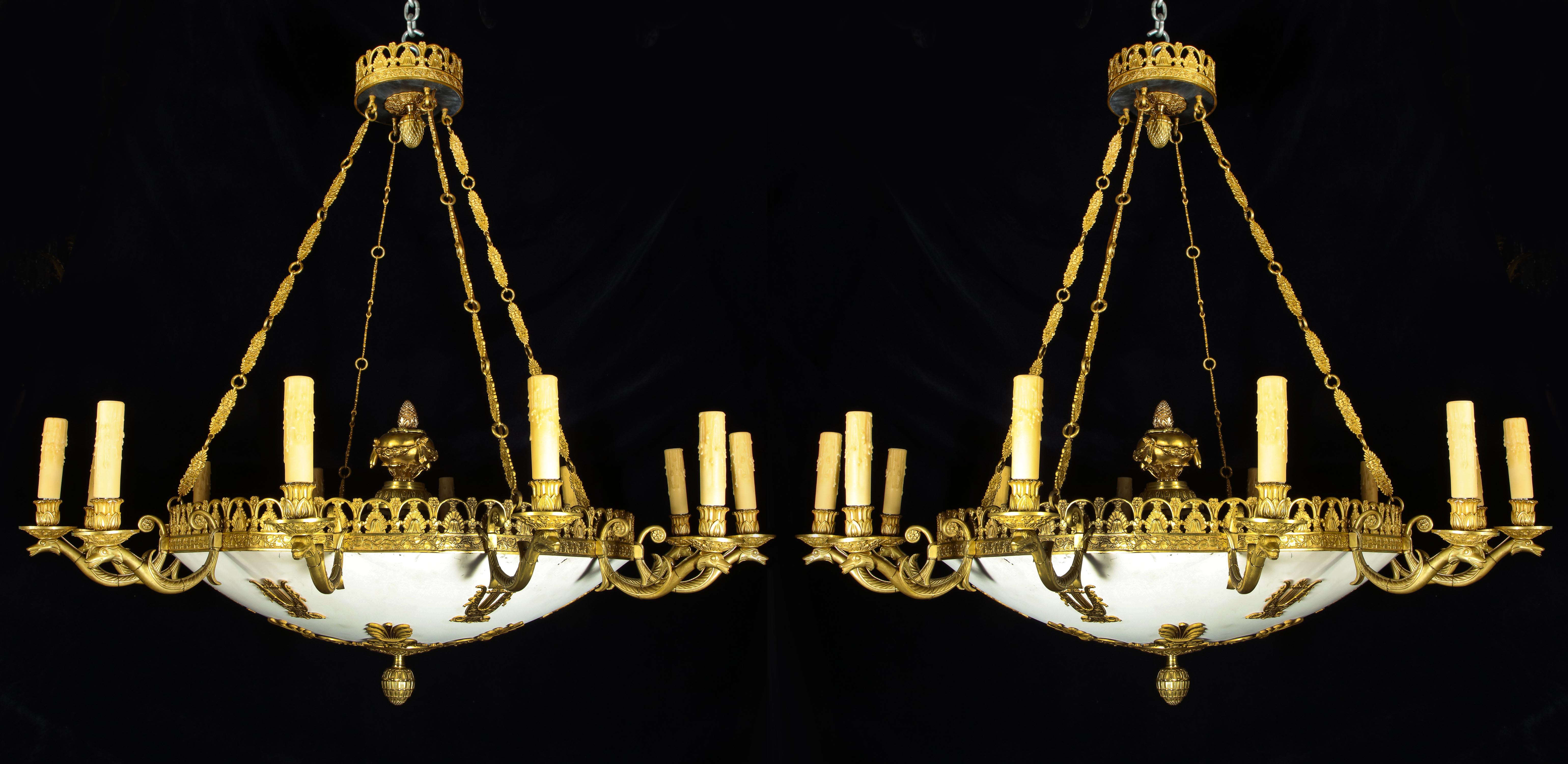 Pair of large and spectacular important antique French Empire neoclassical gilt bronze and white patinated multi light chandeliers of superb quality and detail. These chandelier are embellished with a white patinated central dish and further adorned