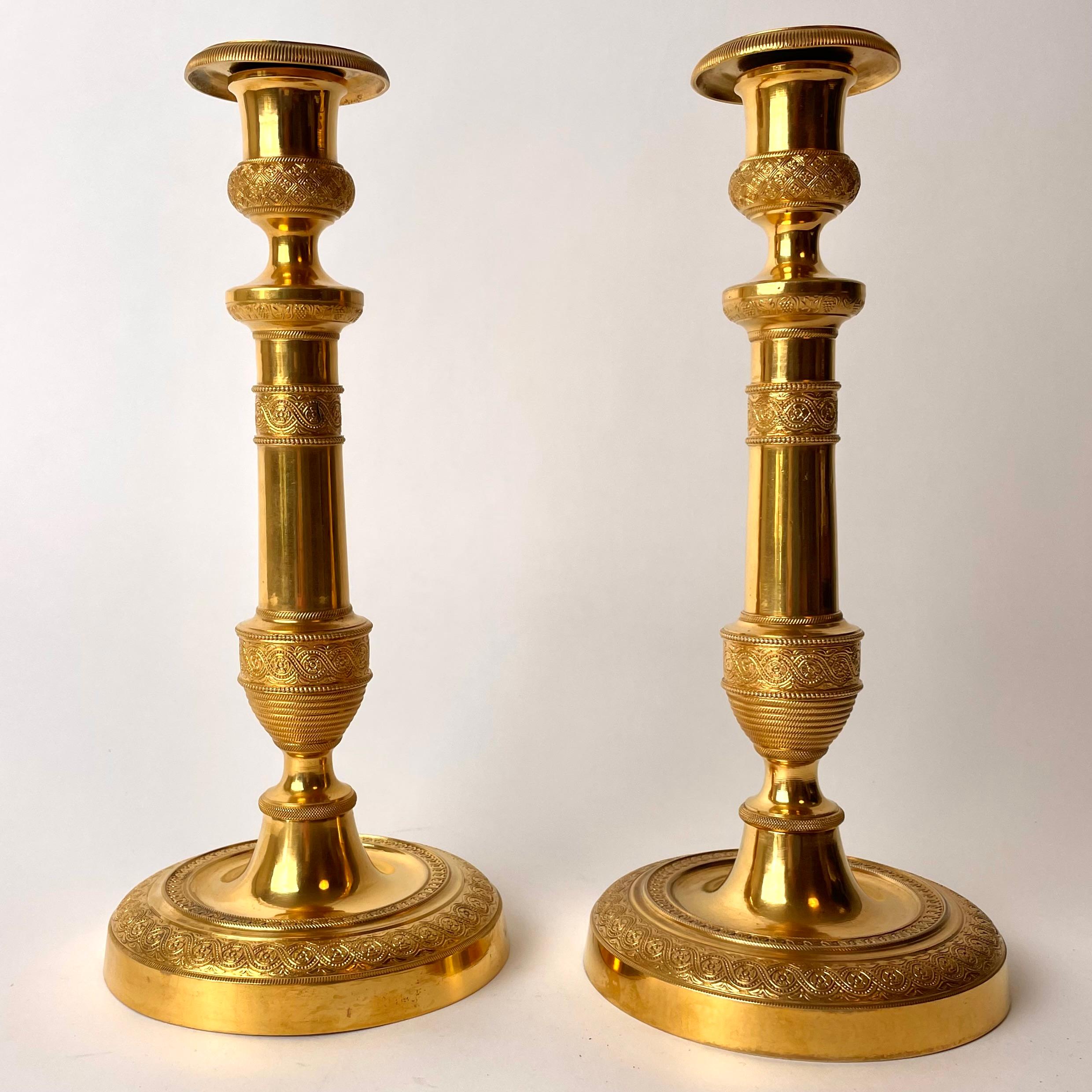 A pair of Large and Sophisticated Empire Candlesticks. Made in France during the 1820s. Very good original gilding and beautiful decoration of these large candlesticks. 


Wear consistent with age and use.
