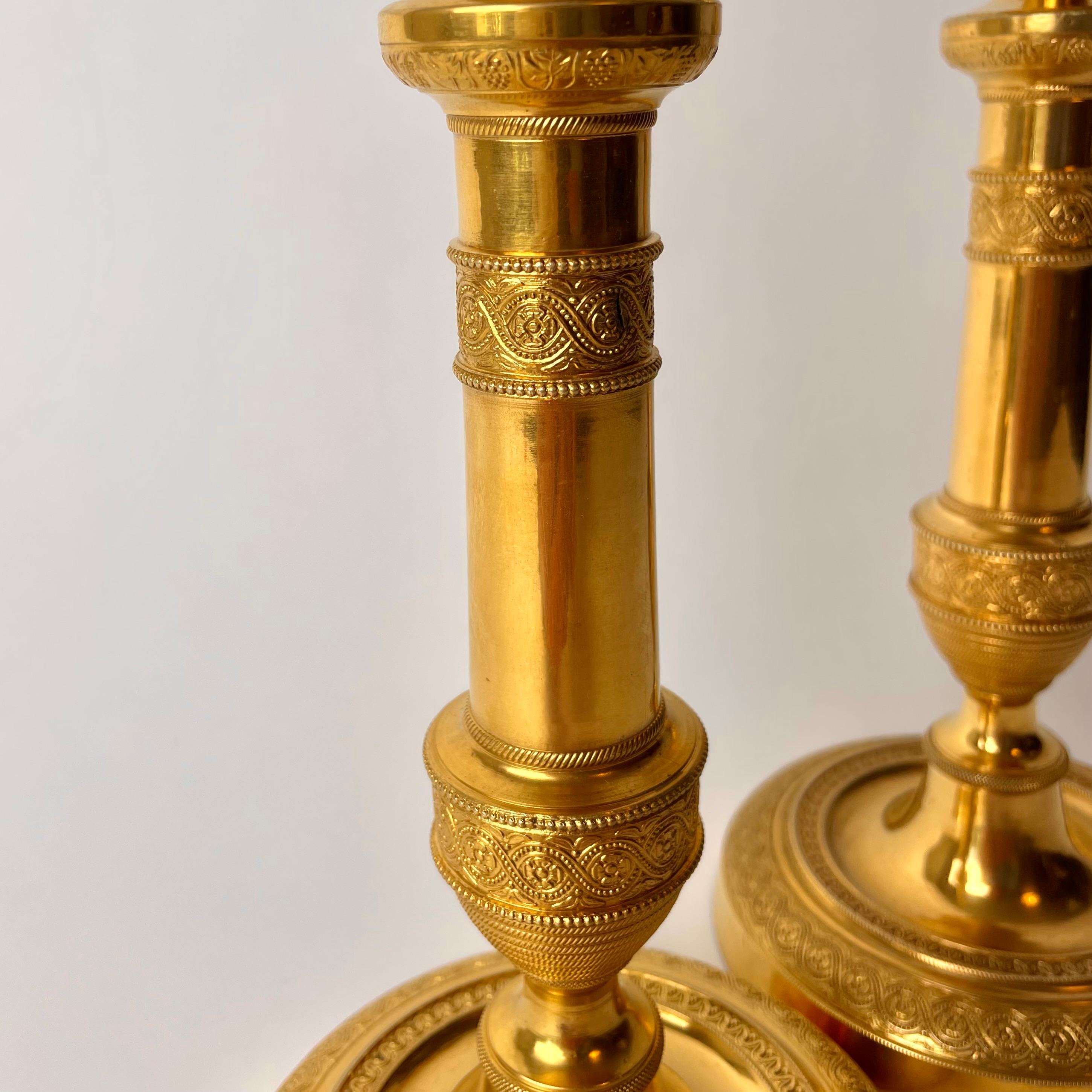 Gold Plate Pair of Large and Sophisticated Empire Candlesticks in Gilded Bronze