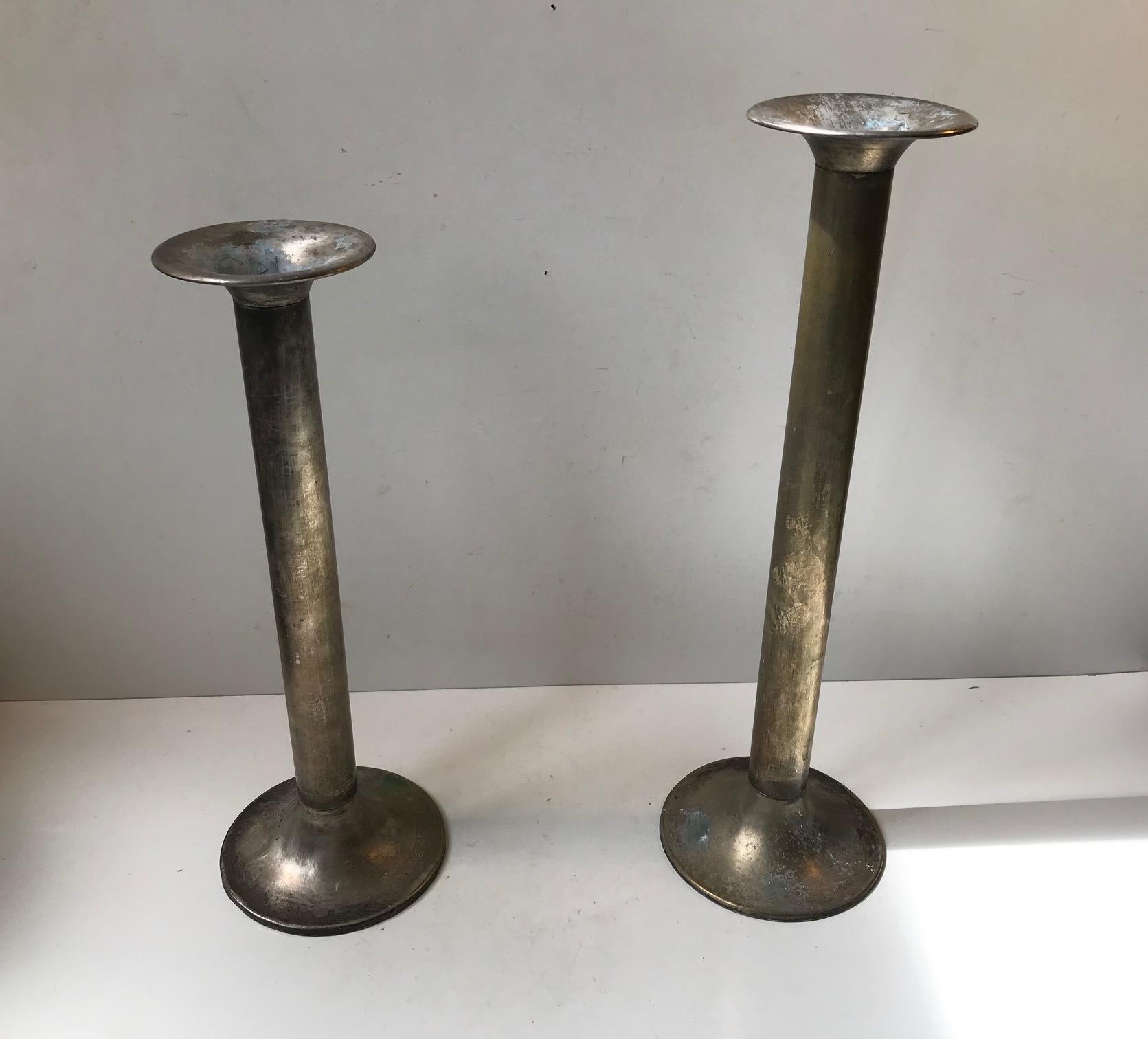 A pair of large antique church candlesticks I silver plated brass. These came out of a Church near Tjaeborg in the western part of Denmark. The design is very plain, peasantry and almost has an Art Deco appearance to them. They have not been