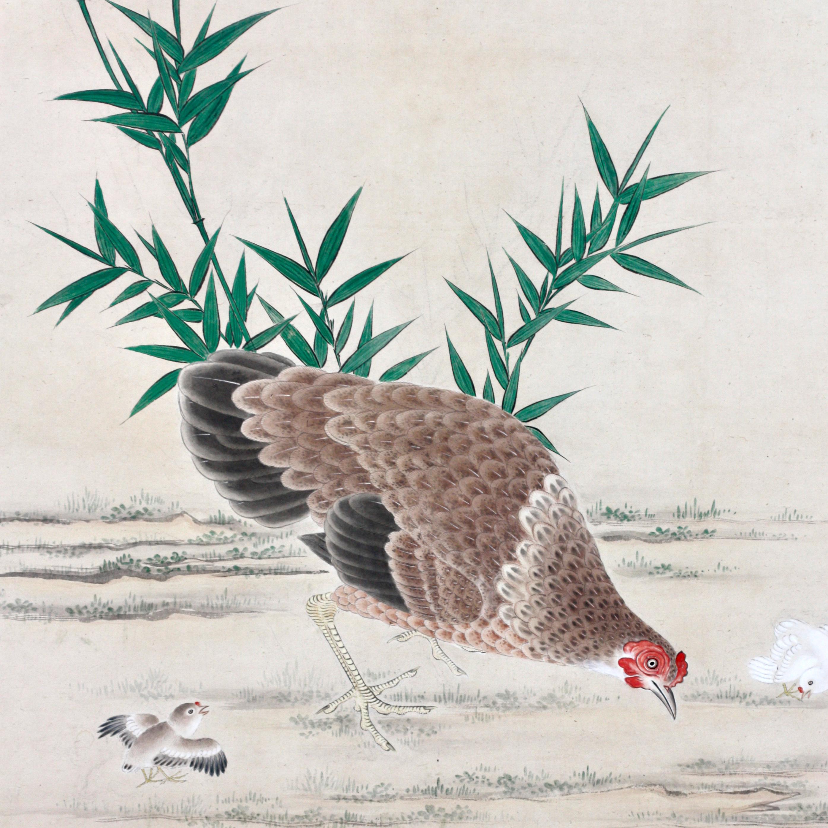 A pair of large antique Japanese paintings of Cockerel and Hen with chicks among timber bamboo. Mounted in the single panel screen panel style of 