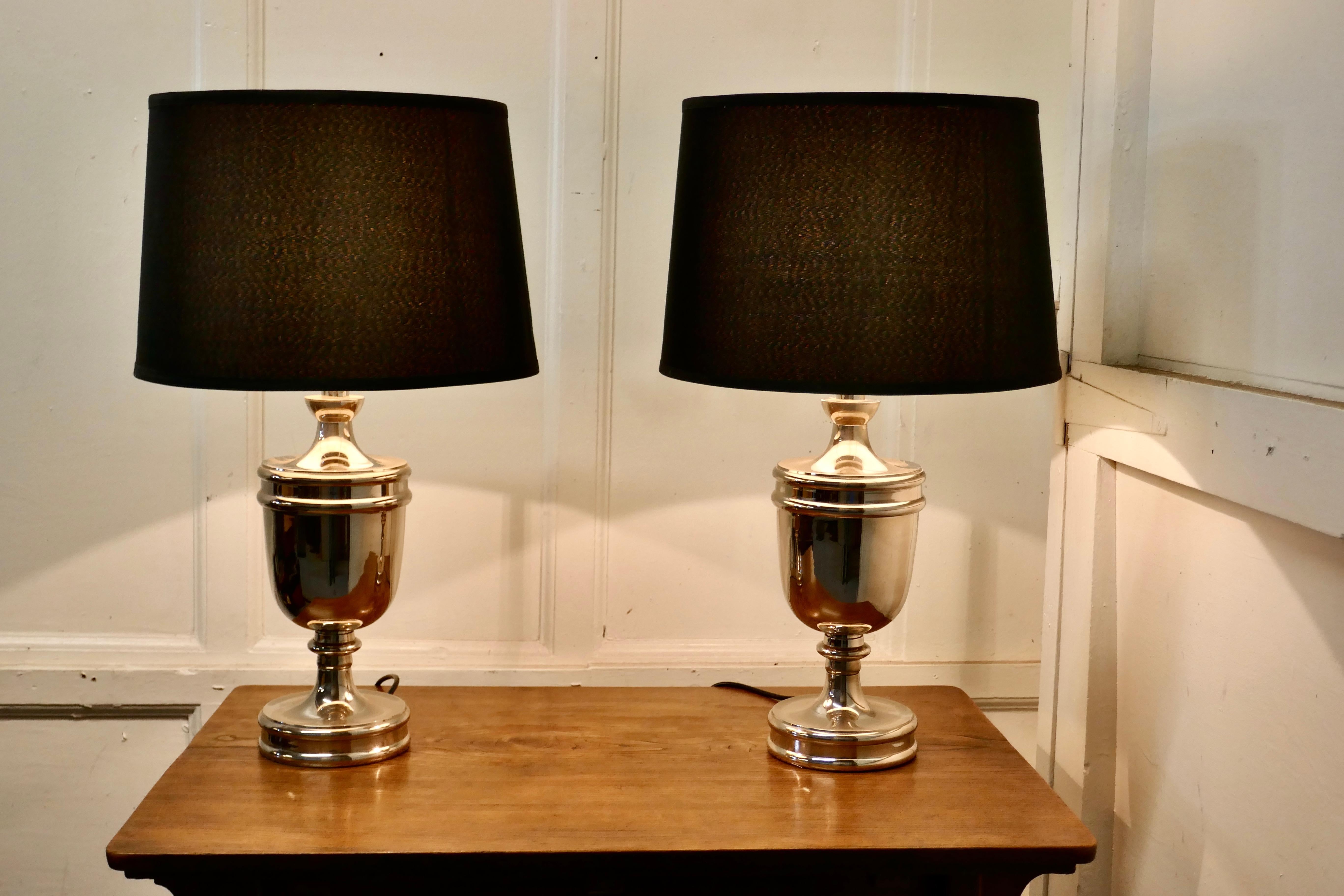 A pair of large Art Deco style chrome table lamps with black shades

These large stunning lamps have a chrome urn shaped base and large black fabric shades, giving the pair an Art Deco look

The lamps are fully wired and in very good condition,