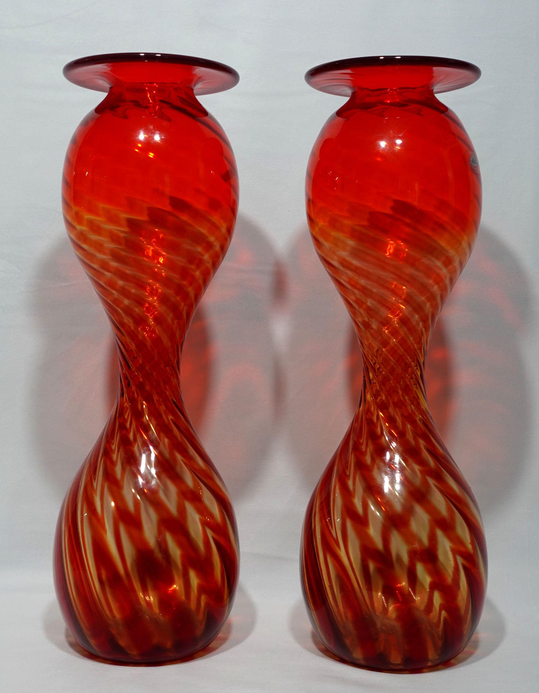A Pair of Large Blenko Handblown Hourglass Optic Oversized Glass Vases, Milton, West Virginia, c 1970

A Pair of oversized glass optic vases by Blenko. A model #2129, the vases have hourglass shapes and have red and yellow stripes with the original