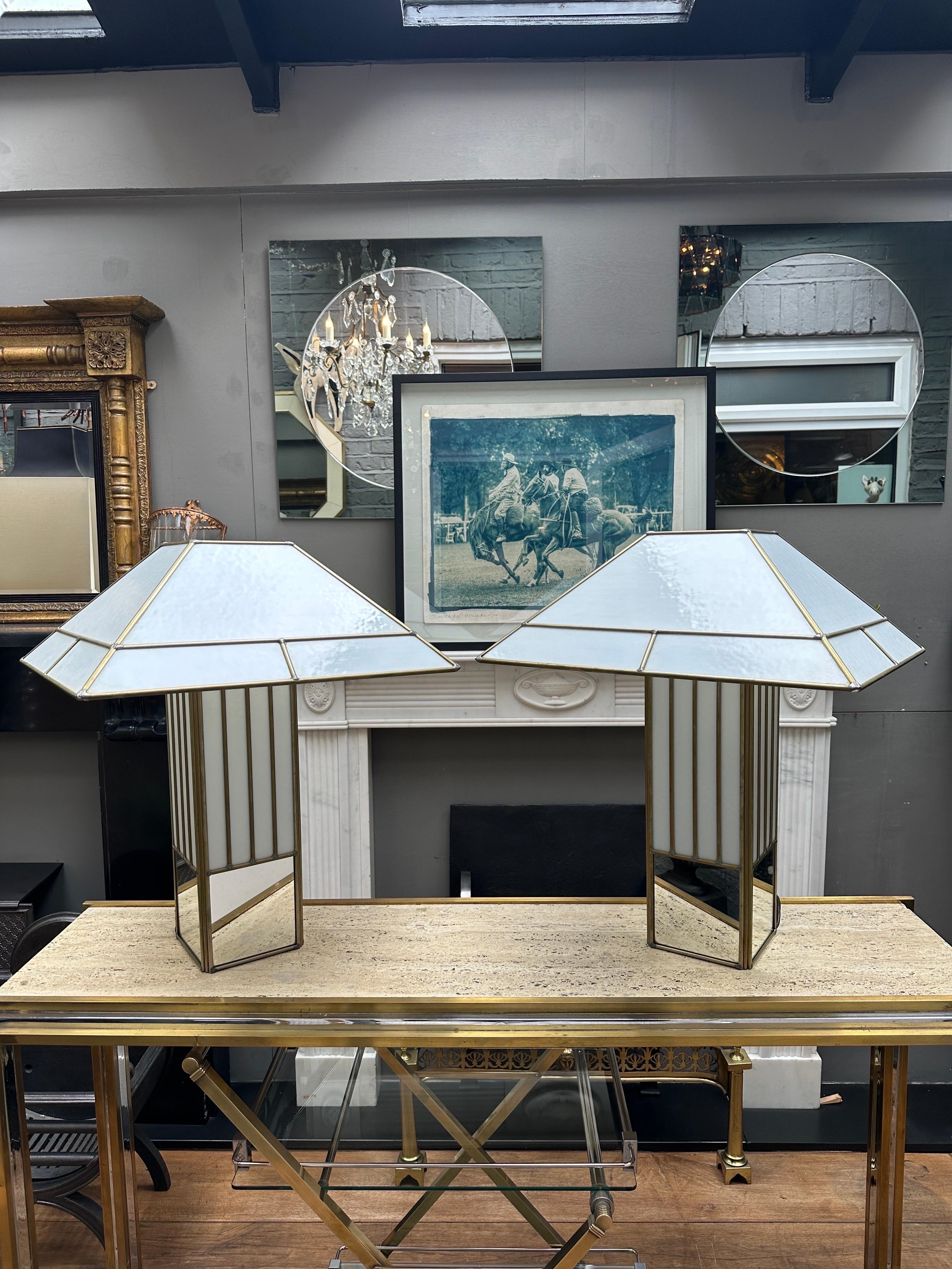 A Pair of large white glass and brass table lamps with mirrored bases, attributed to Poliarte. Quite Art Deco in style with a touch of the Tiffany design. However a good quality pair of table lamps large in scale with good form and quality. 