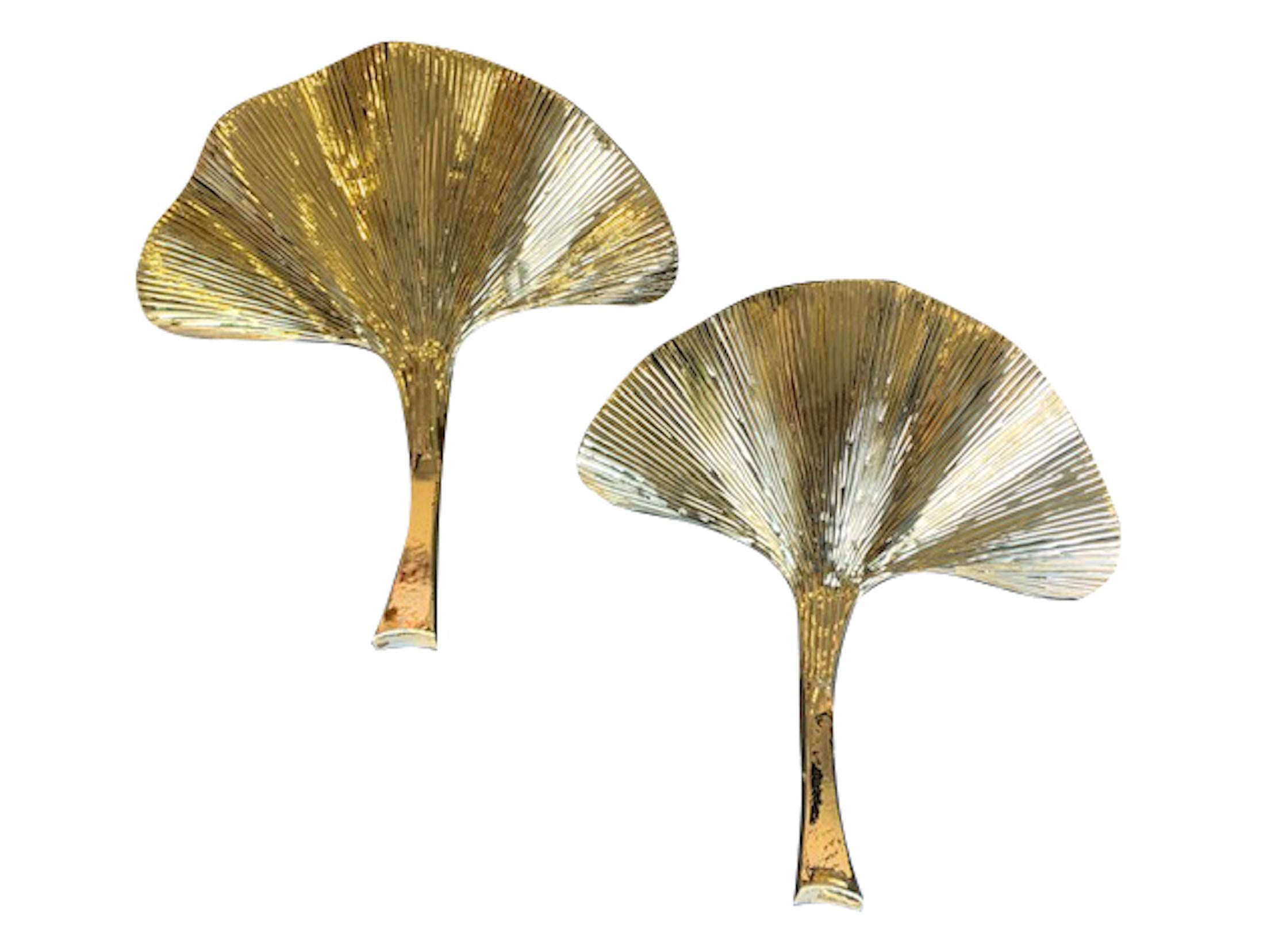 A pair of stunning large brass finish Gingko leaf wall sconces in the style of Tommaso Barbi. Each has a large leaf and stem that curves out, with a single fitting at the back which the leaf hangs from.