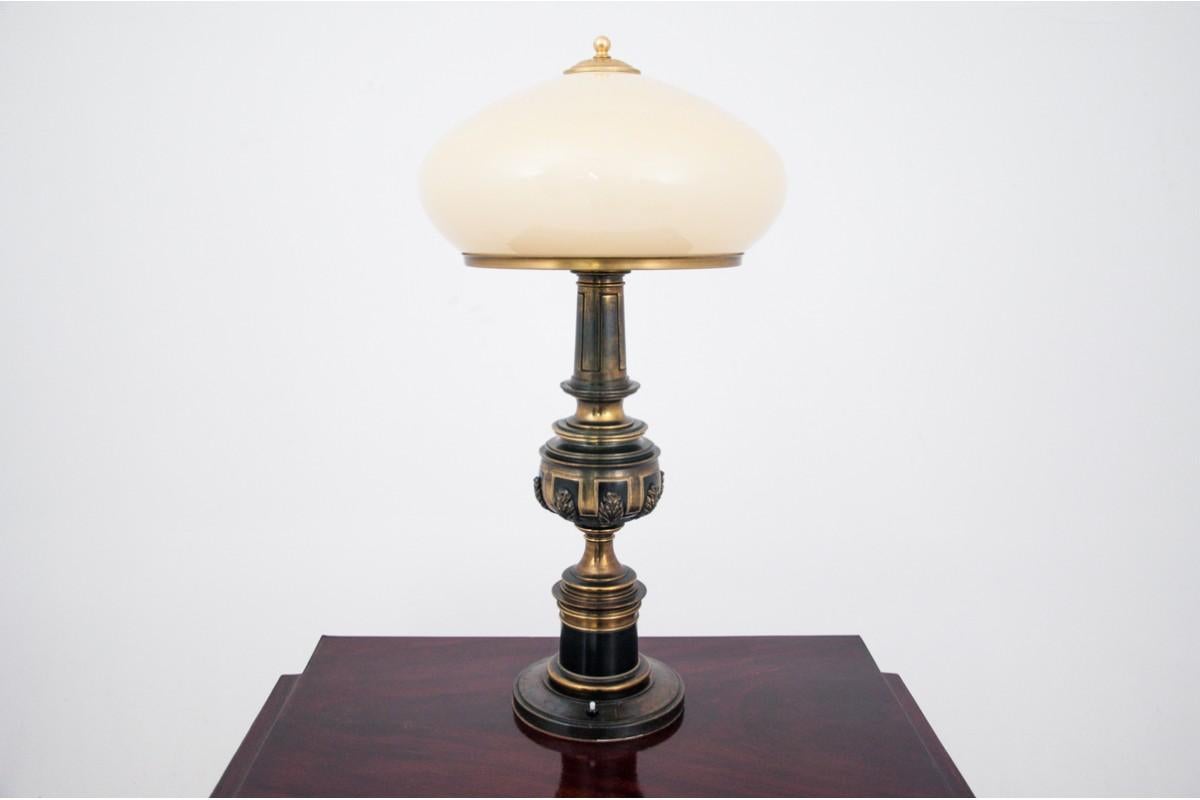 A pair of large table lamps made of brass and beige glass shade. 
Produced in France in the 1940s.
Very good condition, no damage. 
New wires, European plug.

dimensions: height: 76 cm, width: 40 cm.