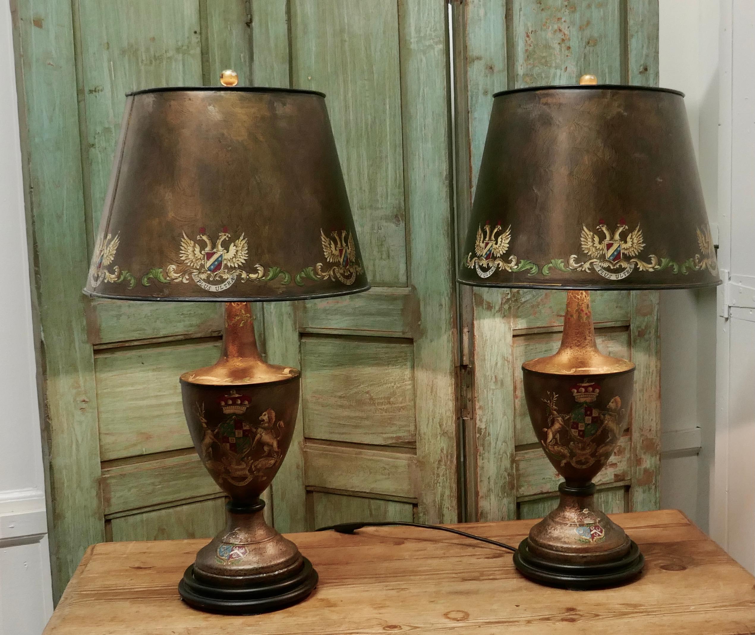 A pair of large bronze colored toleware table lamps

These large stunning lamps have an armorial crest theme they have matching shades, both lamps and shades have a crackle glaze finish and are hand painted 
The lamps are fully wired and in very