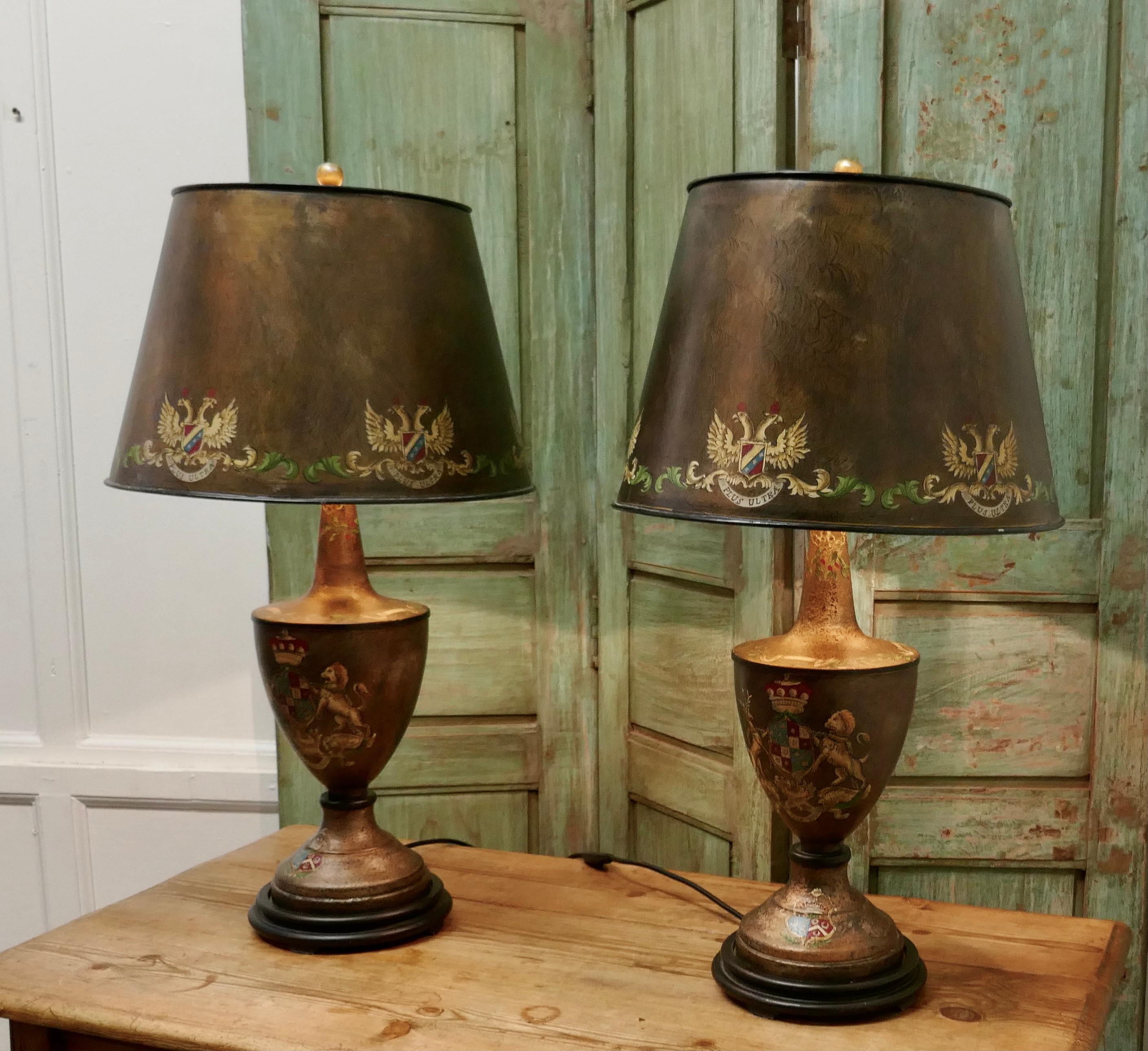A Pair of Large Bronze Coloured Toleware Table Lamps

These Large Stunning Lamps have an Armorial Crest theme they have matching shades, both lamps and shades have a crackle glaze finish and are hand painted 
The lamps are fully wired and in very