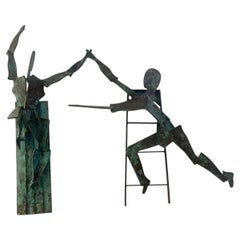 A pair of large bronze figurative wall hanging sculptures, 20th century