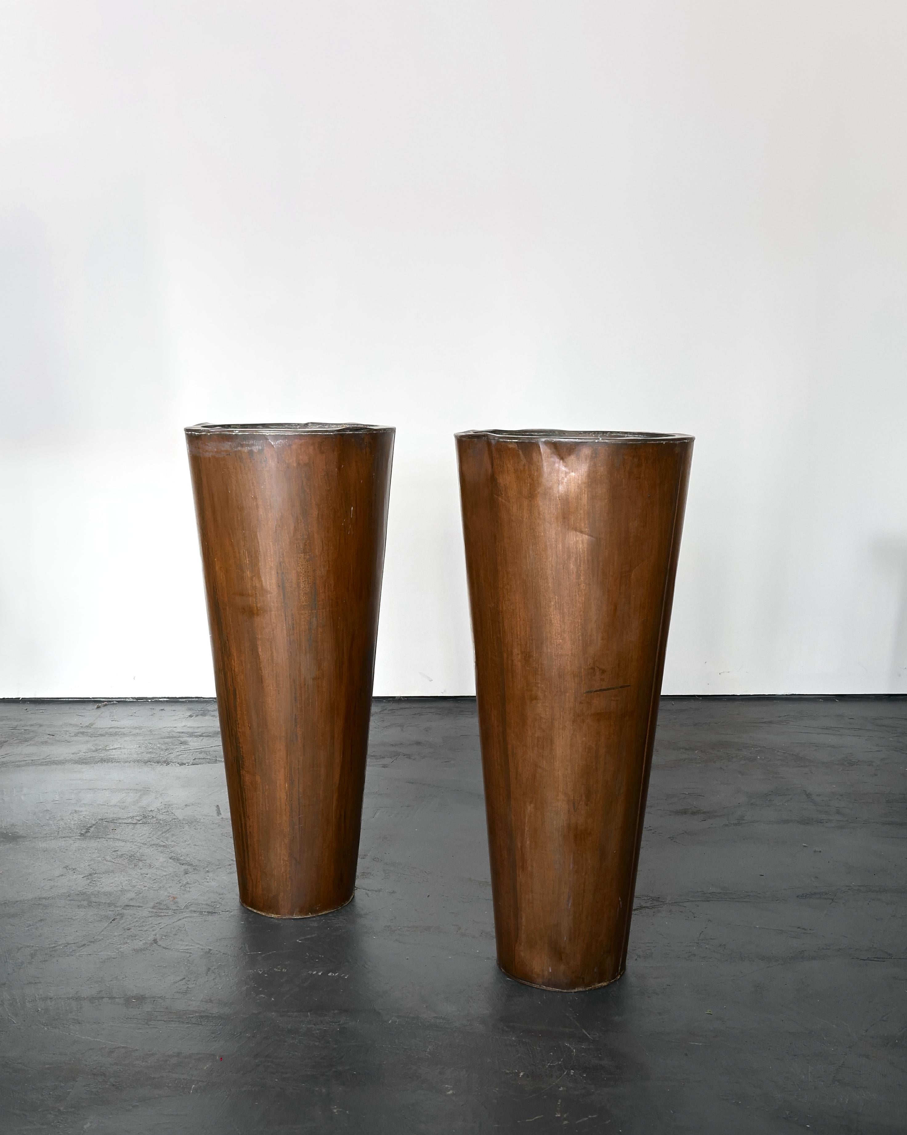 A pair of large copper planters from the French mediterranean.

Originally used at the entrance of a restaurant.

Nicely patinated with some age related wear.

W49.5 cm x D49.5 cm x H116 cm 

Opening measures roughly 41.5cm diameter