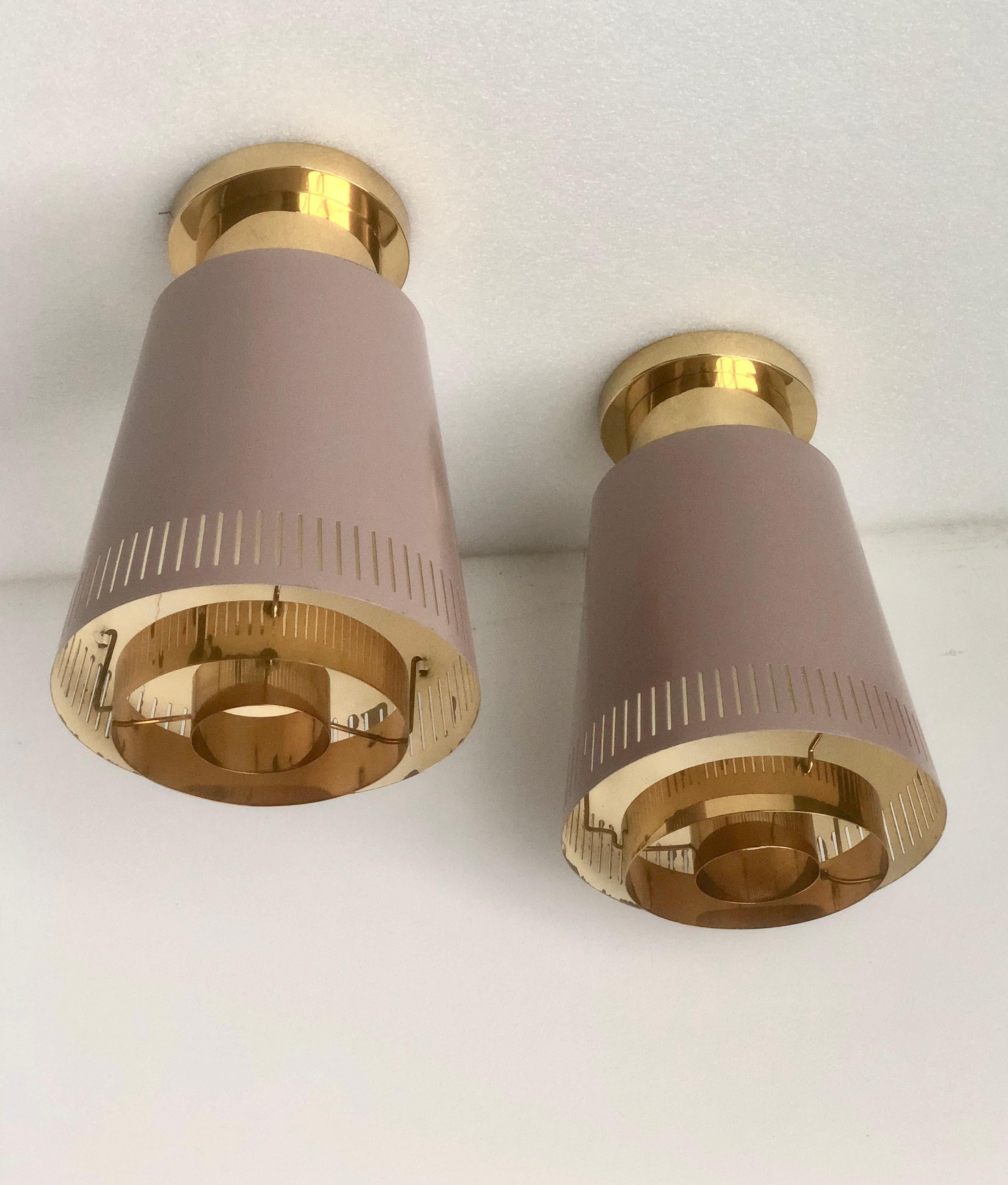 Scandinavian Modern A pair of large  ceiling lights by Paavo Tynell, Model 9067
