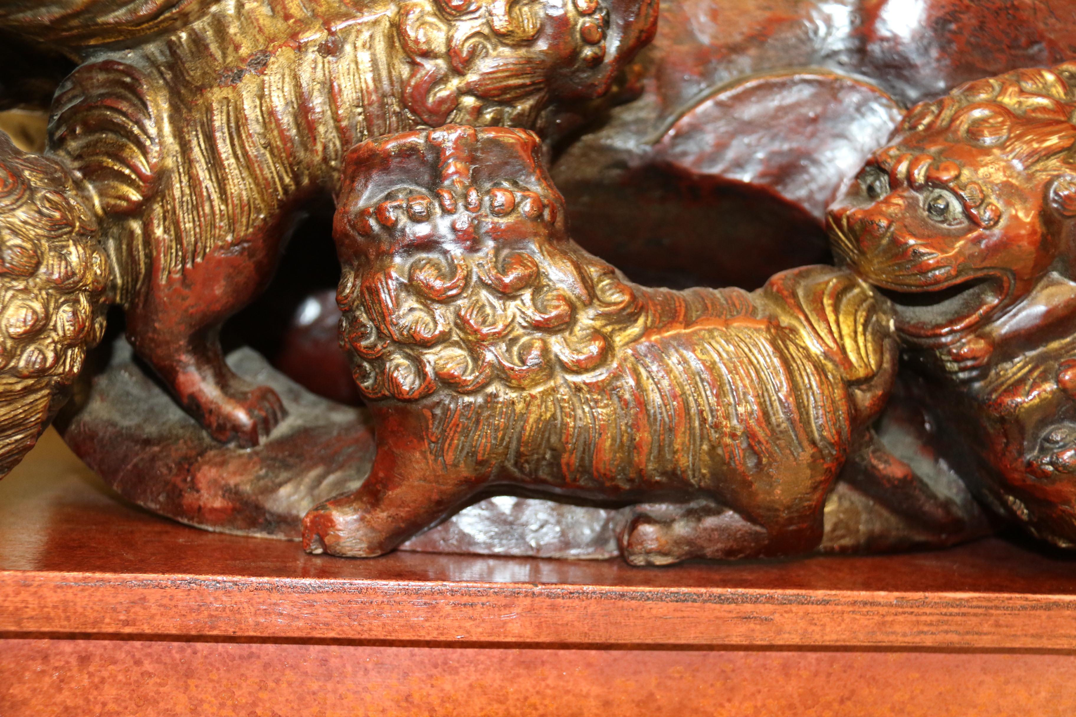 Lacquered A Pair of 19th century hardwood Chinese Mythical Beasts/Dogs of Foo on Stands  For Sale