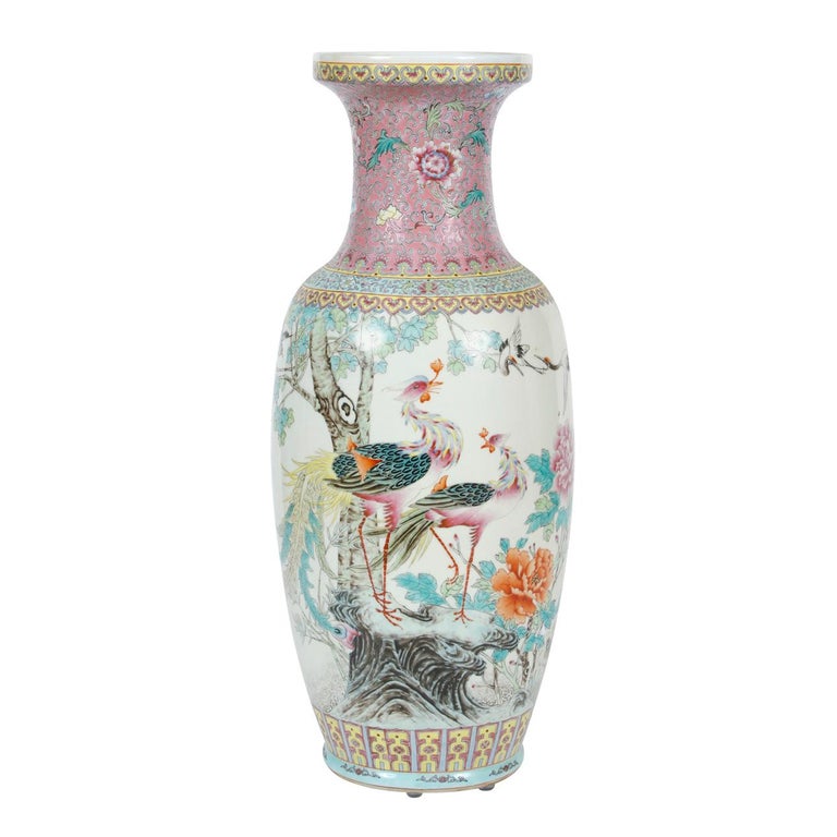 A pair of large Chinese export pink vases with peacock and floral decoration.