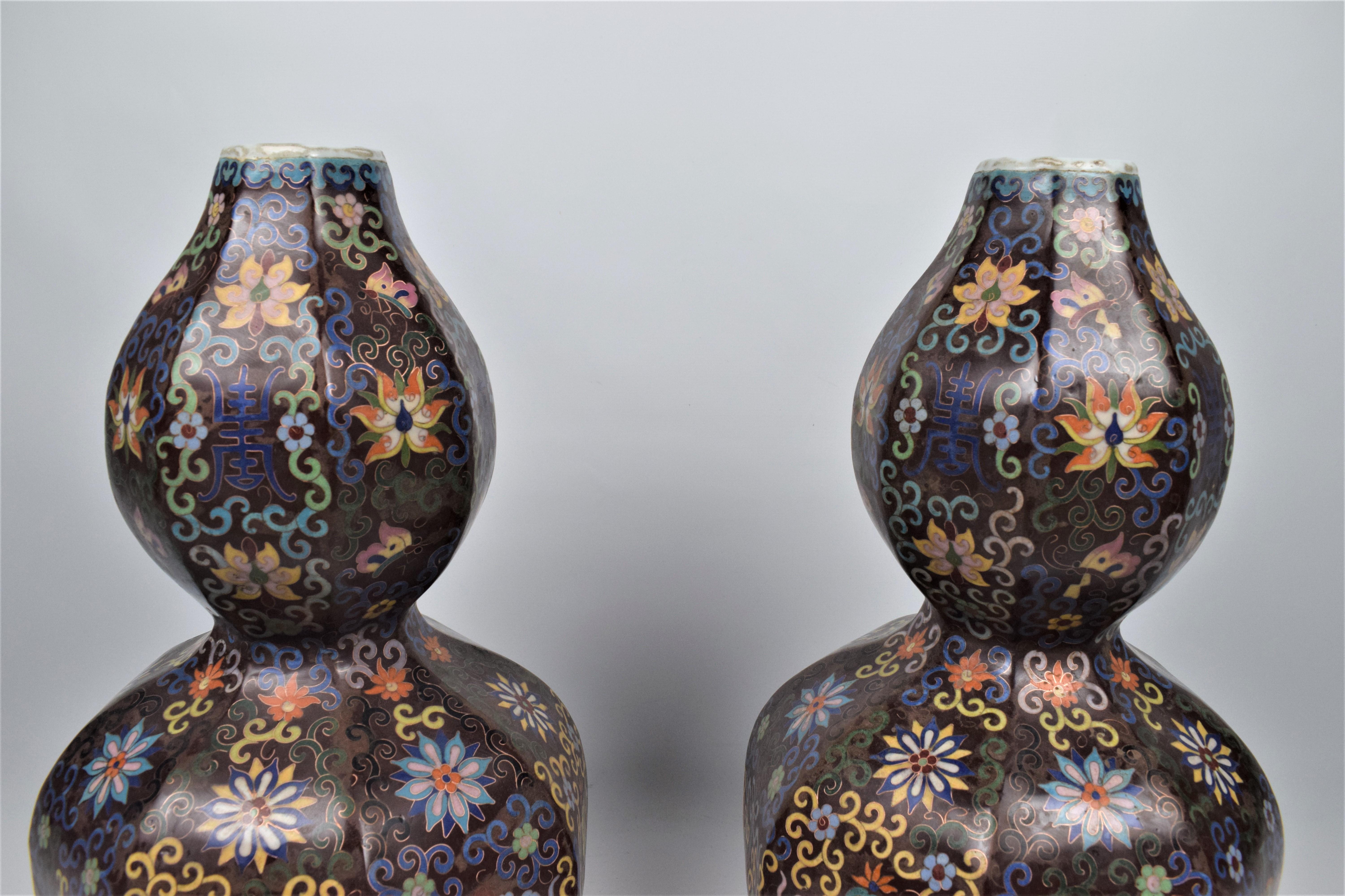 A Pair Of Large Cloisonne´ Enamel Double Gourd Bottle Vases Late Qing Dynasty, 19th century

The Chinese bottle vases are made of porcelain with an intricate enamel cloisonné floral design. These spectacular vases are in double gourd bottle form.