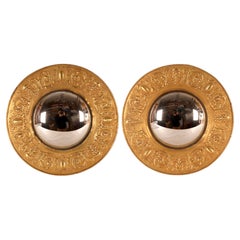 A pair of large convex mirrors, embossed brass frames. Italy, late 19th century.