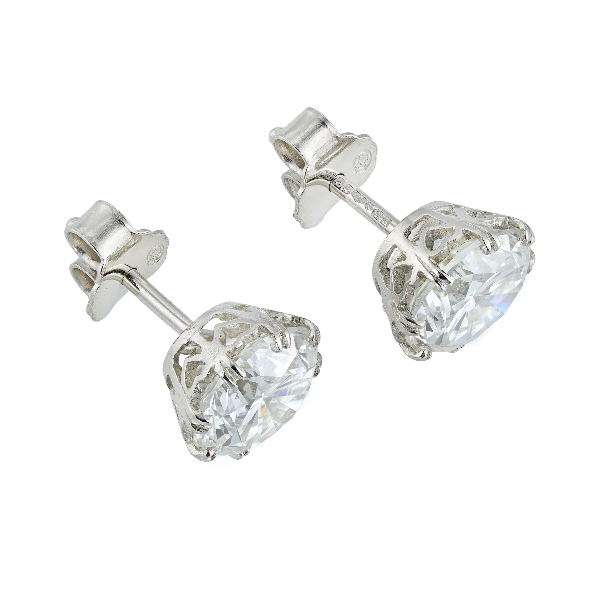 A pair of large diamond stud earrings, the one earring with a round brilliant-cut diamond weighing 2 carats, accompanied by GIA report stating to be of I colour and SI1 clarity, the other with a round brilliant cut weighing 2.01 carats, accompanied