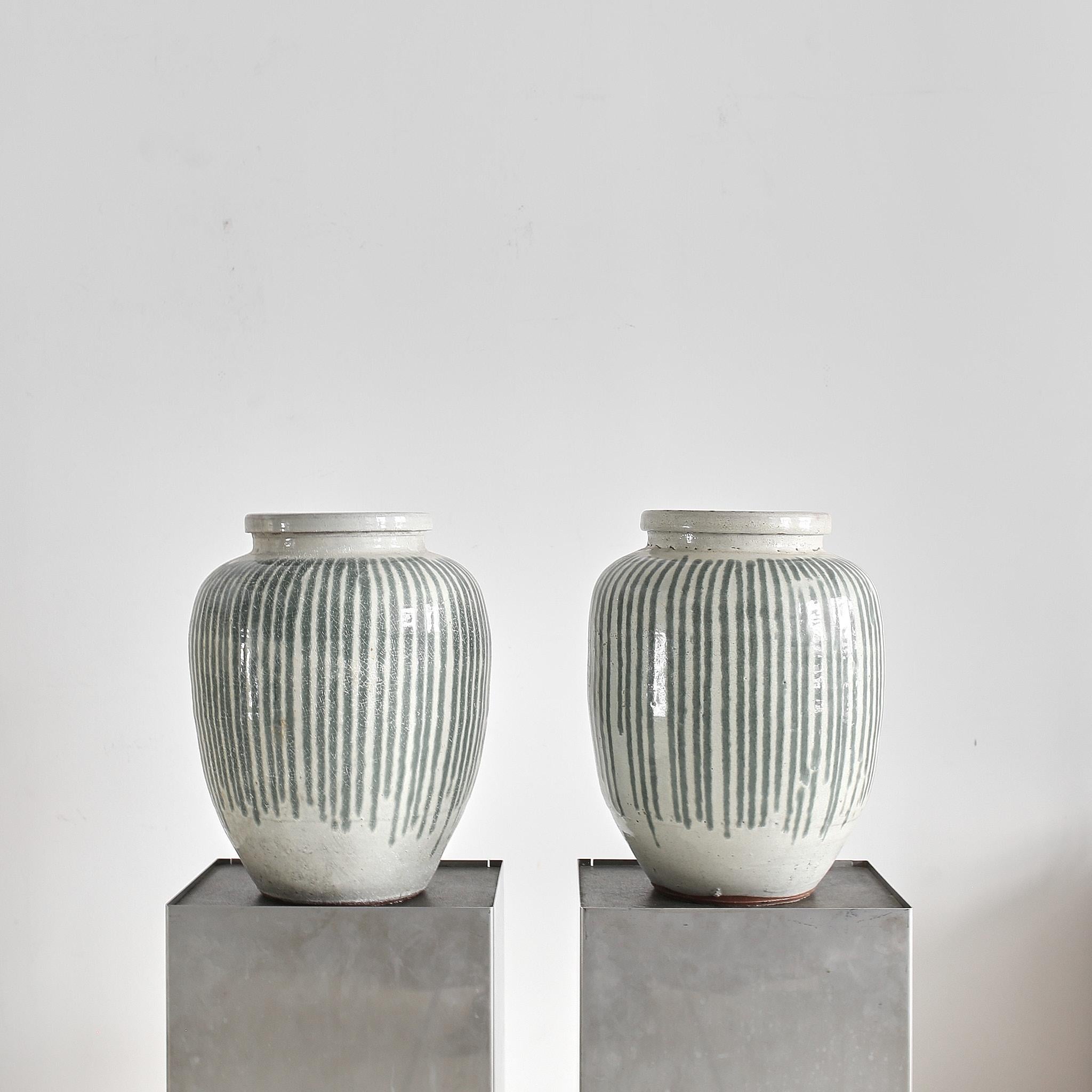 A pair of C.1930s crackled glazed off white & green stripped planters from Japan.

Especially rare as a pair.