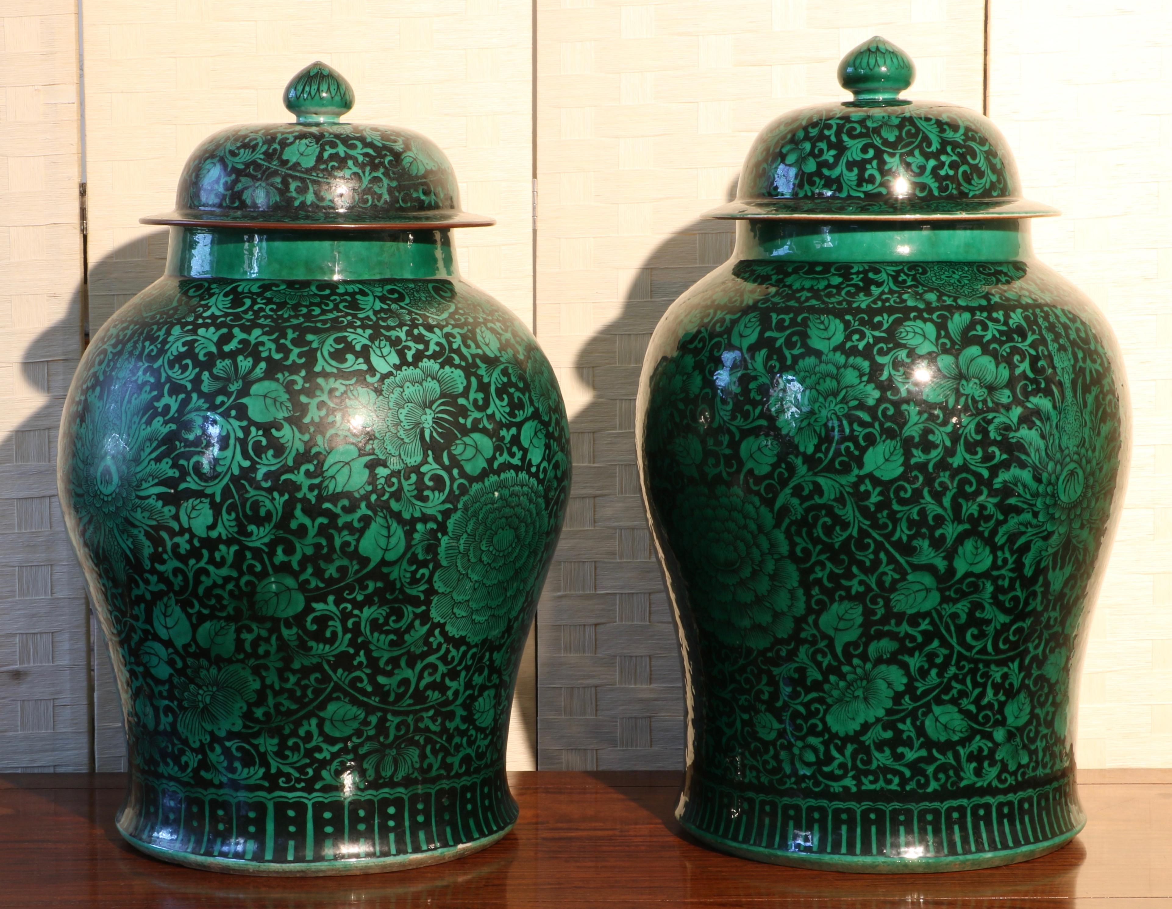 A pair of large Famille Noire Baluster vases and vovers. Each decorated in green on a black ground with large Lotus and Peony blooms on a floral scroll. E 19th century
Measures: Height 25 1/4