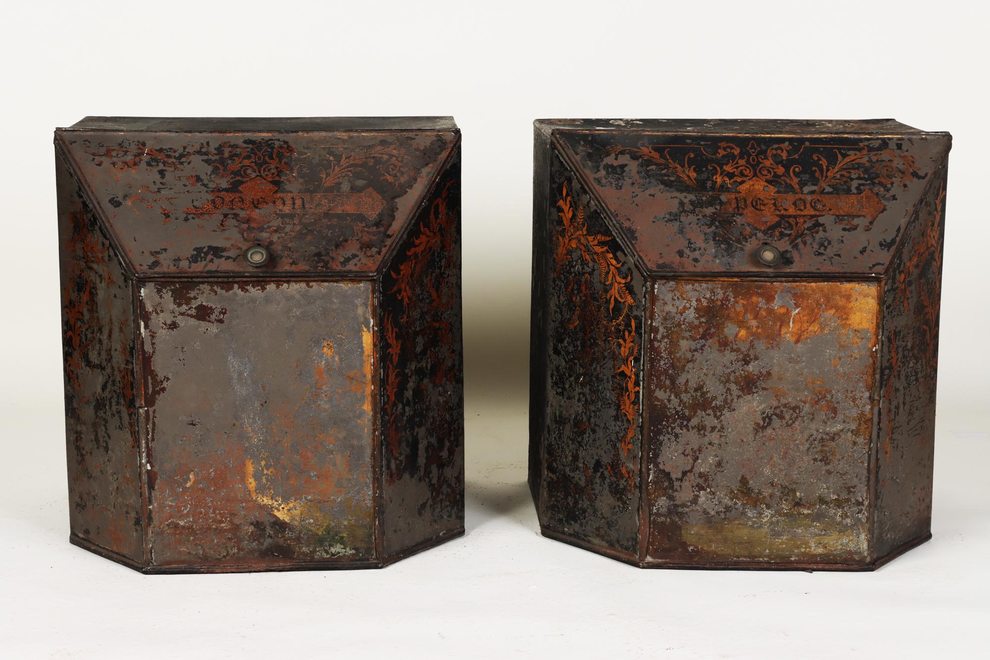A pair of large floor sized Victorian period tin tea caddies, hopper, box bulk tea bins. Original black lacquer and hand painting has wear.
 Slanted Lids are original.
 Work beautiful as bed side tables. Rare to find matching pair.