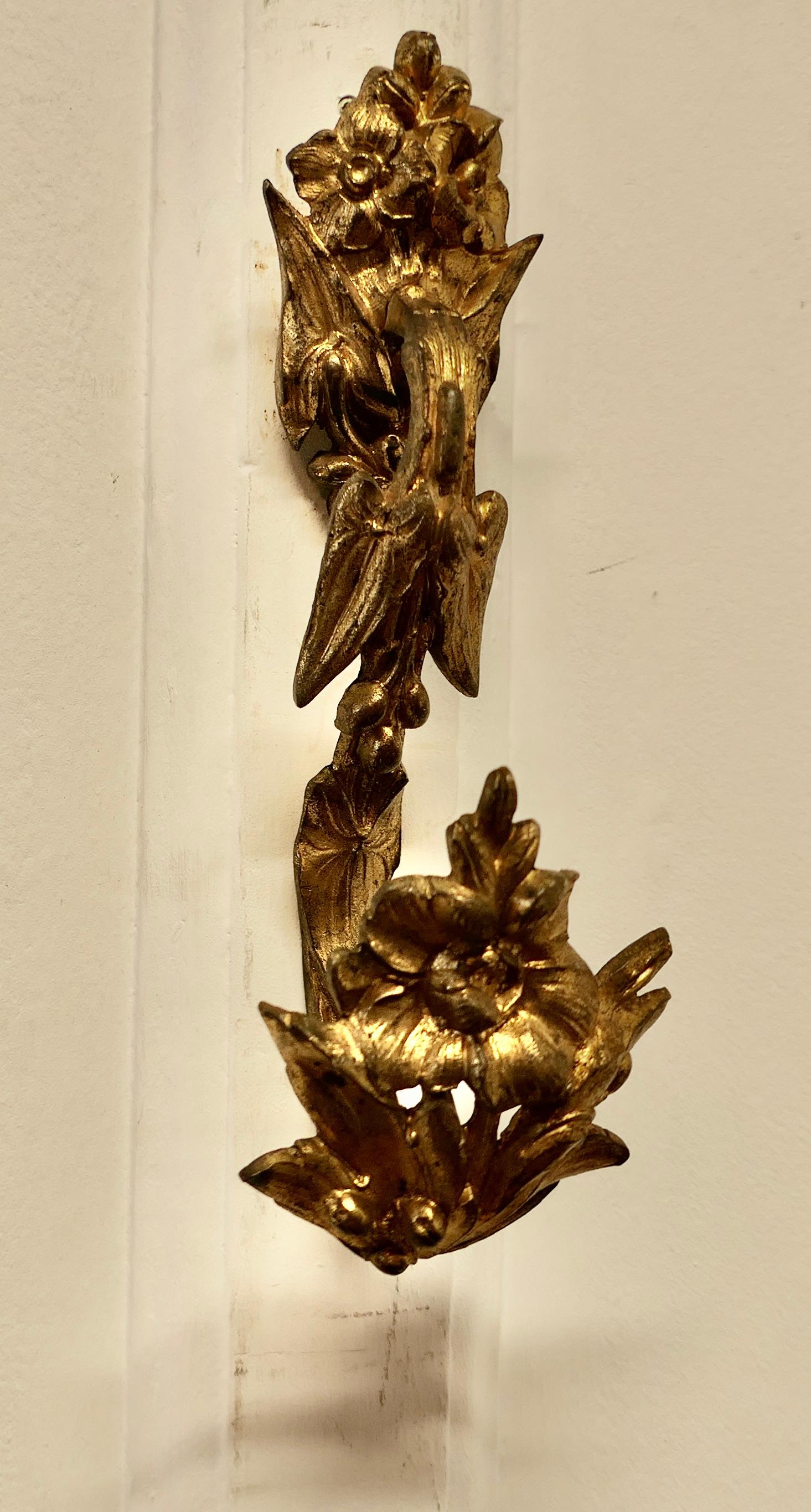 A Pair of Large French Rococo Ormalu Curtain Curtain Tie Backs 


The Tie Backs or Hooks are solid brass, they have flower decoration and are made in brass Ormolu 
 
 The brackets have a flat plate to fix them to the wall, and they are 9” tall, and