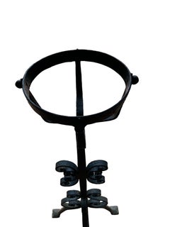 A pair of Large French Wrought Iron Fire Dogs with large fire baskets