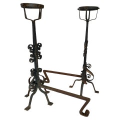 A pair of Large French Wrought Iron Fire Dogs with large fire baskets