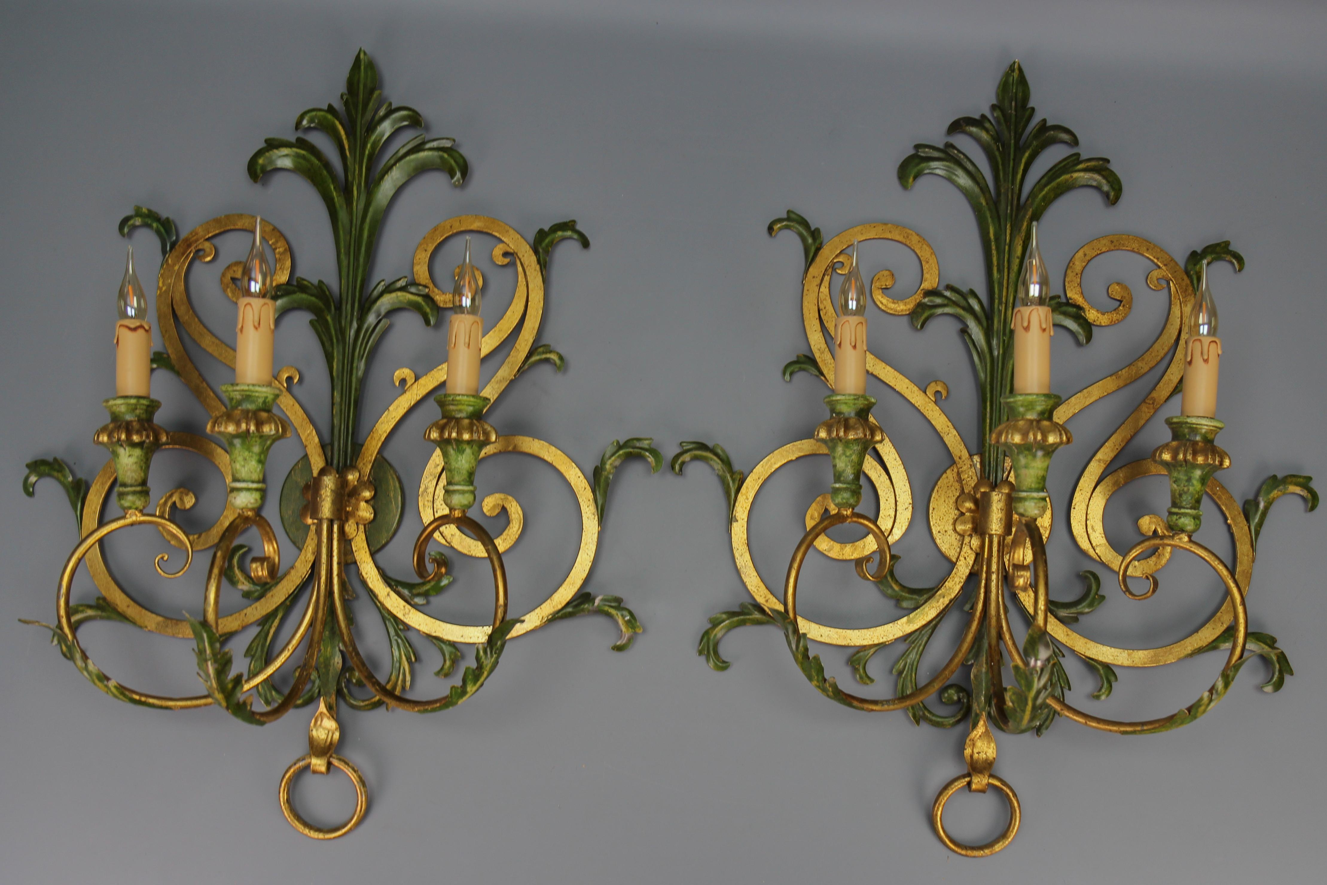 A pair of large gilt and green color metal and wood sconces, Italy, ca. the 1960s.
This impressive pair of Baroque-style sconces features gilt and green-colored metal frames and wooden elements (parts of arms), adorned with scroll and leaf decors.