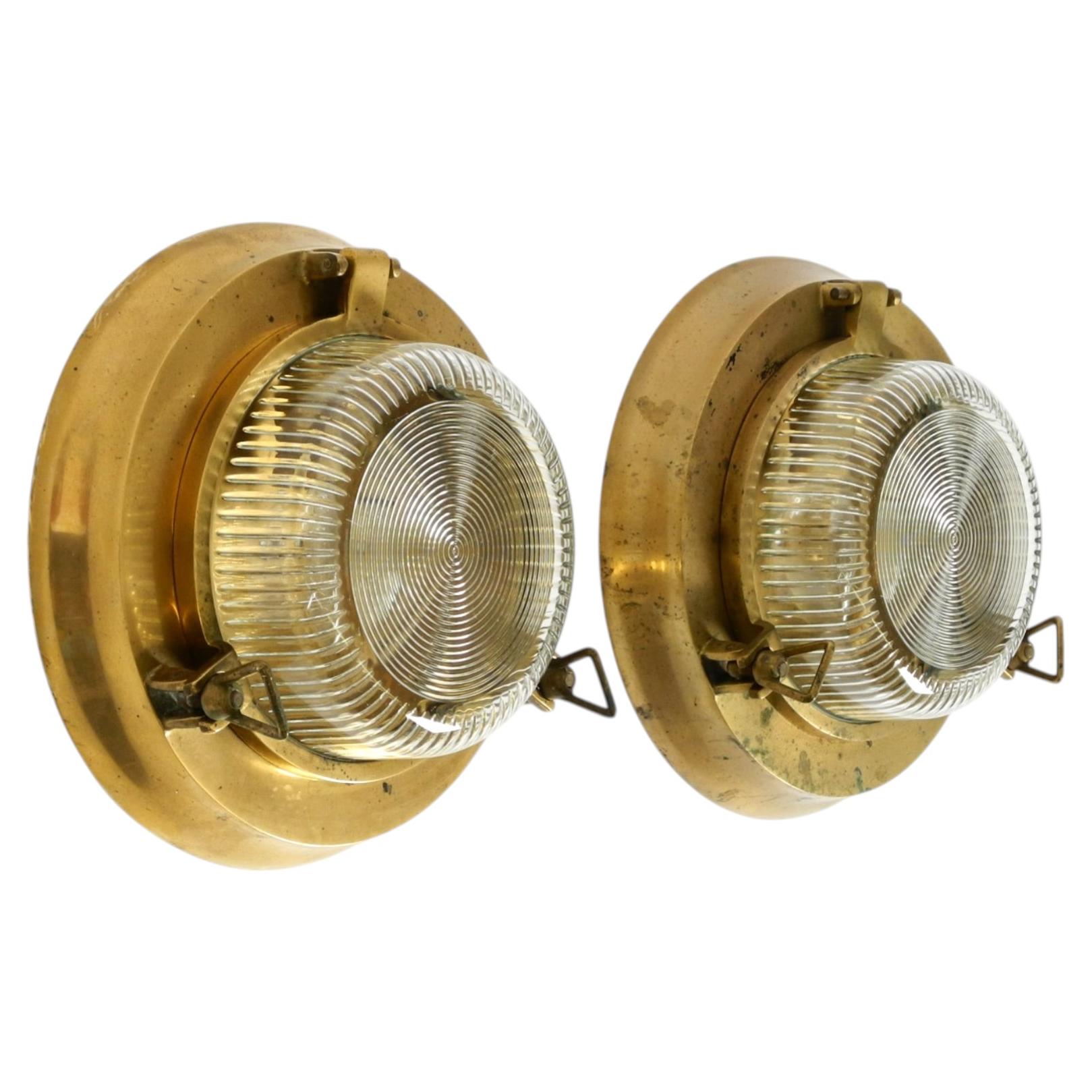 A pair of large, heavy 1950s maritime ship wall lamps made of brass and glass